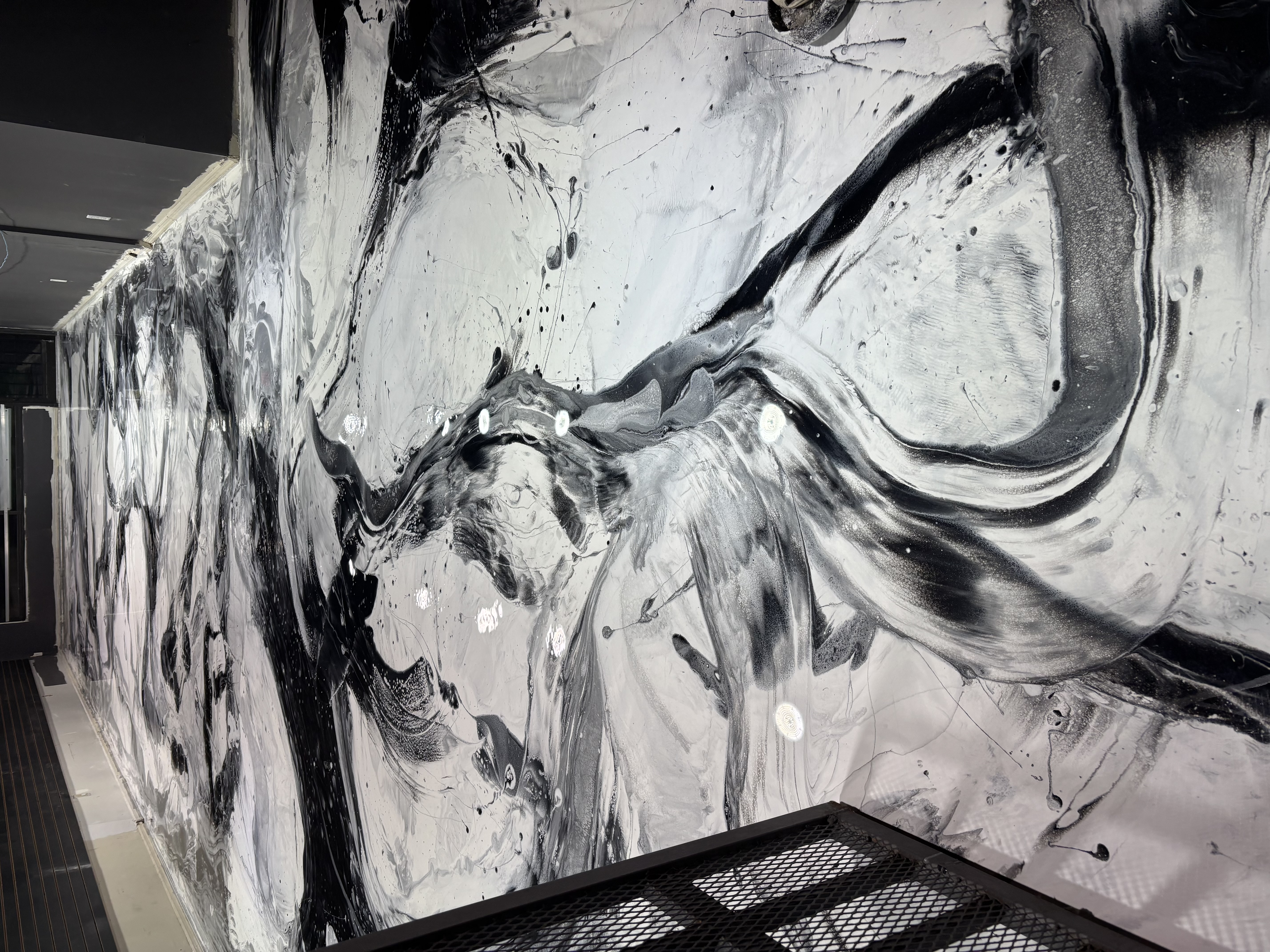 Metallic epoxy flooring with reflective silver and blue swirling finish