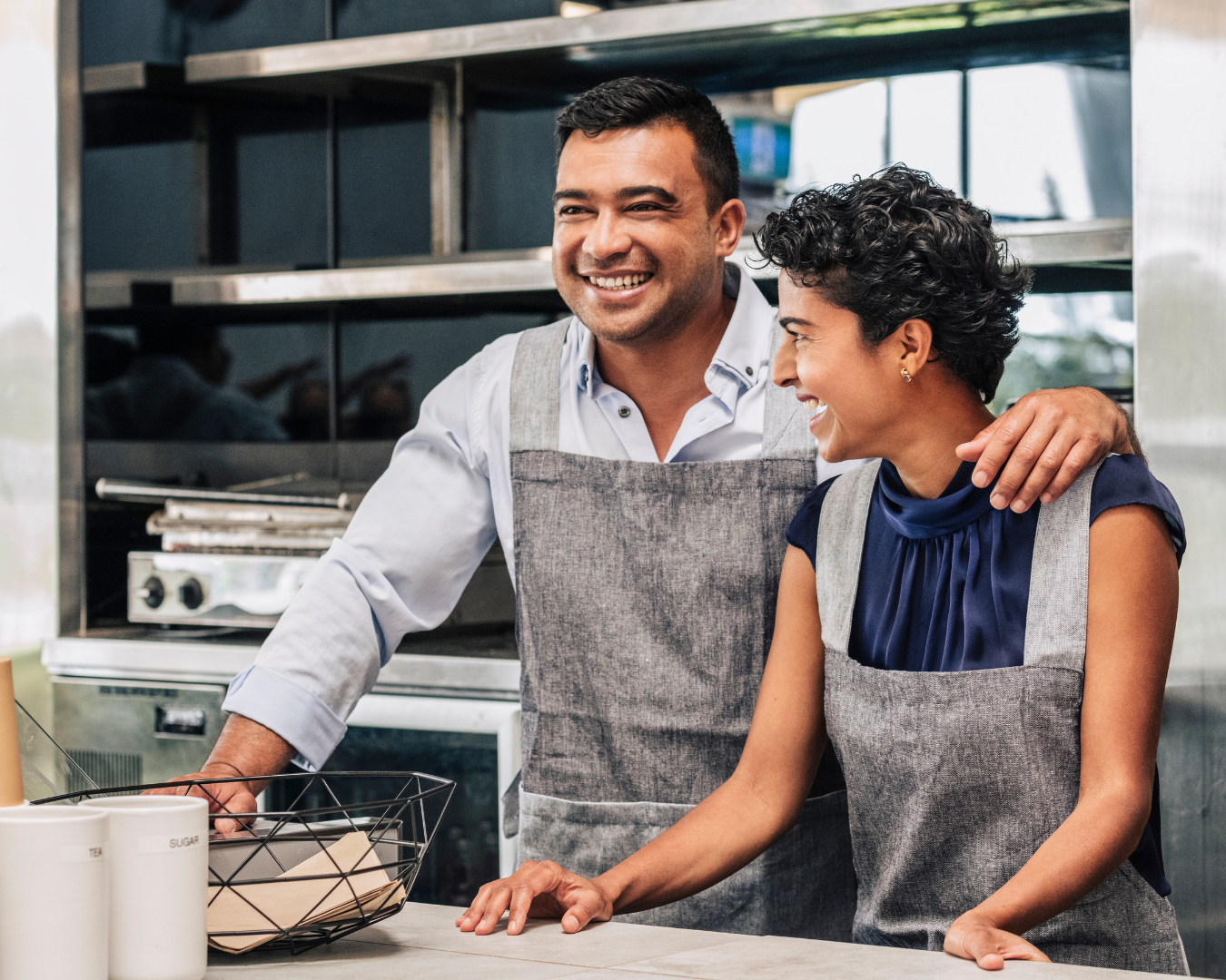 Small business owners smiling in their shop