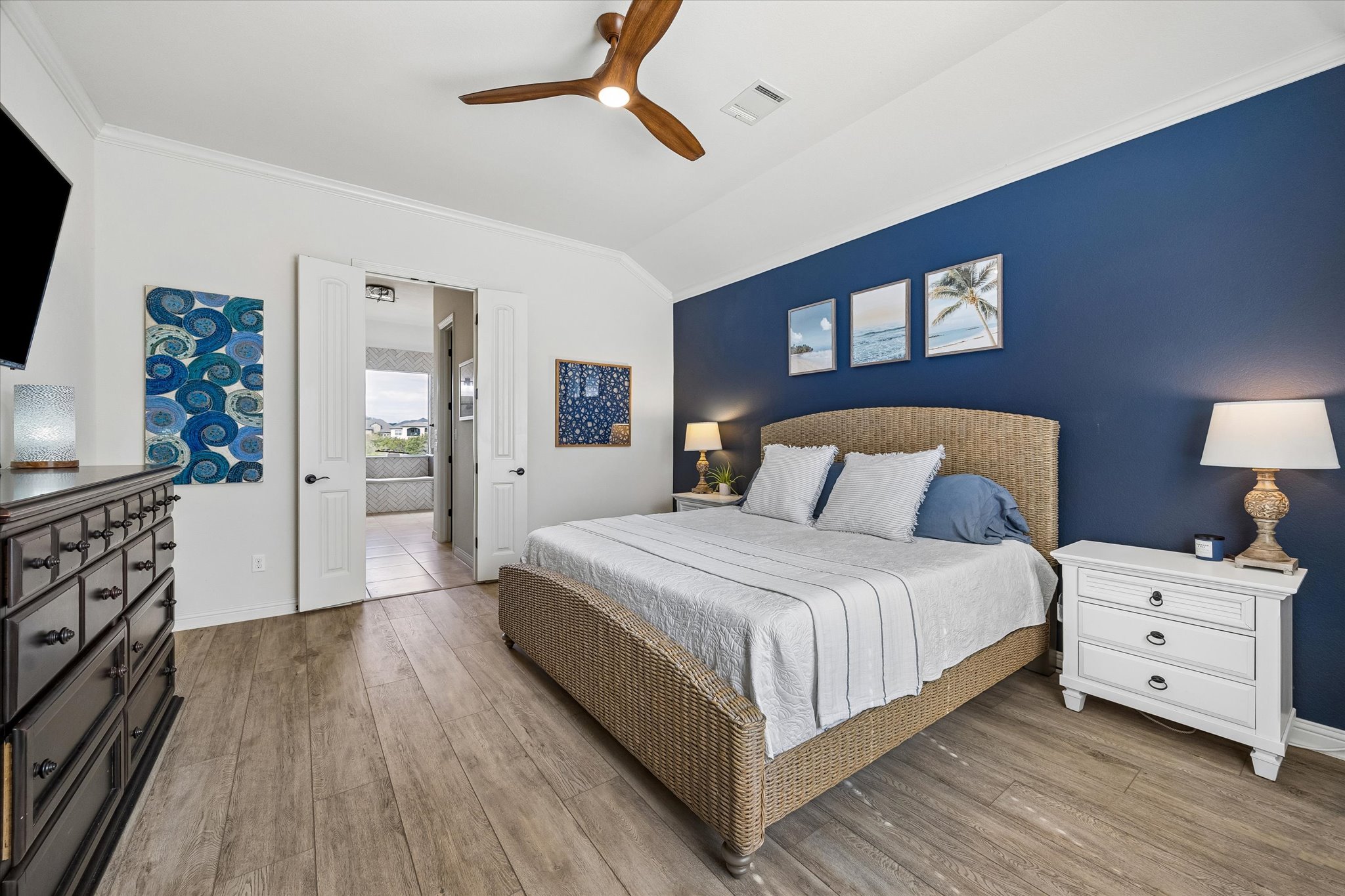 Primary bedroom with crown molding and ceiling fan