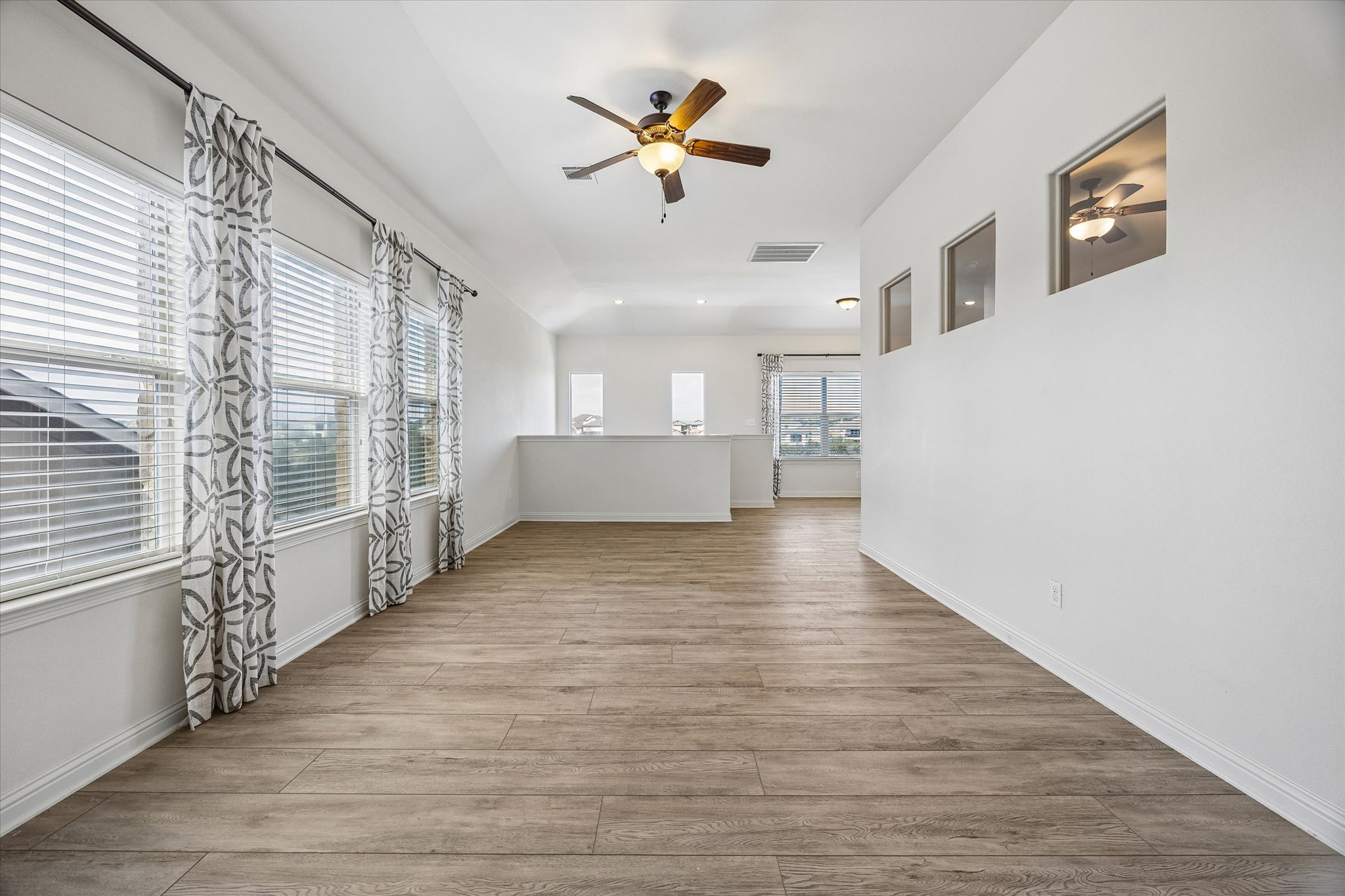 Upstairs game room with ceiling fan