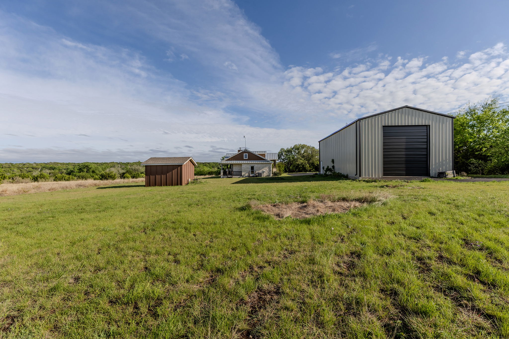 House rear and side view with outbuilding and RV garage