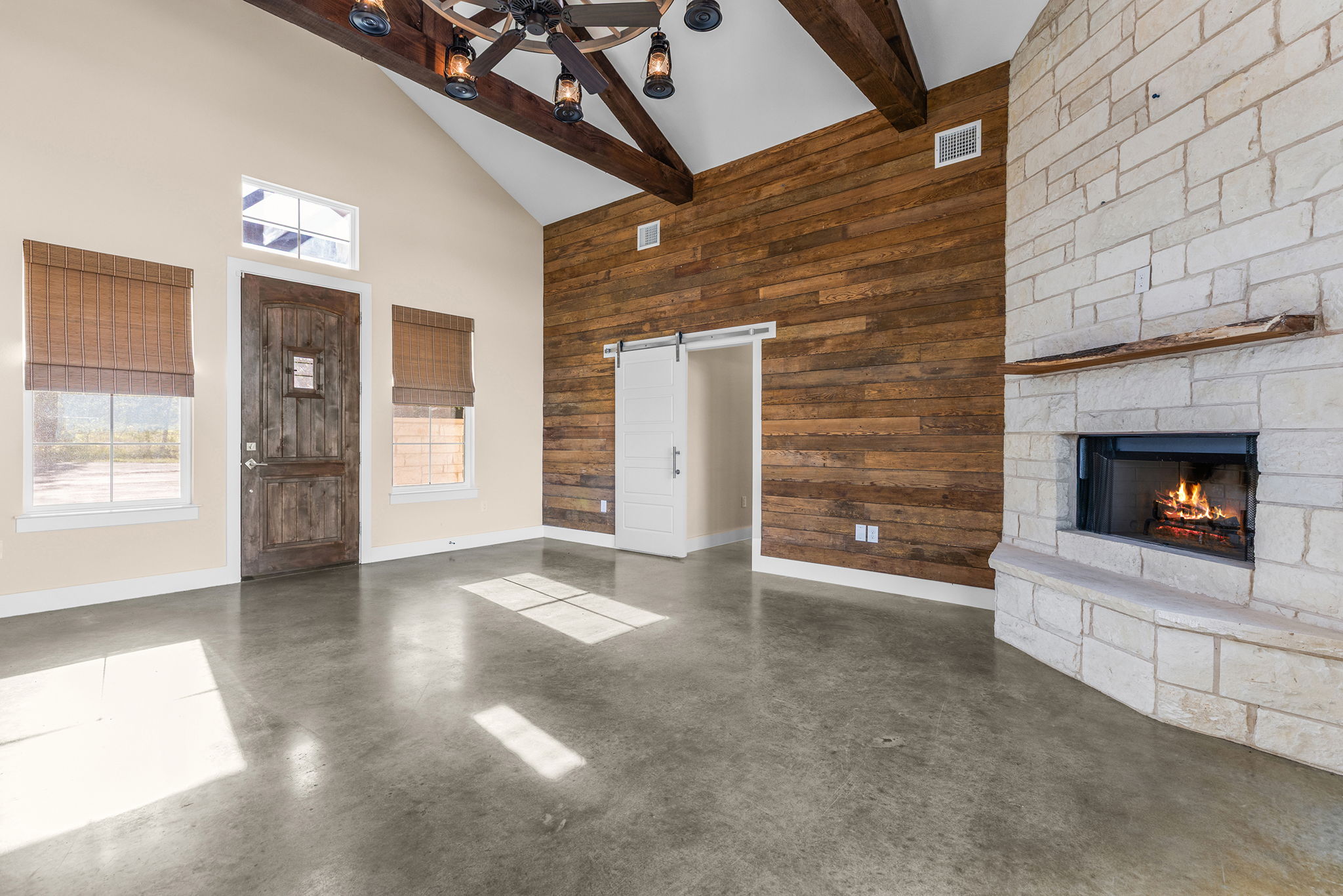 Living room with stone fireplace and shiplap accent wall