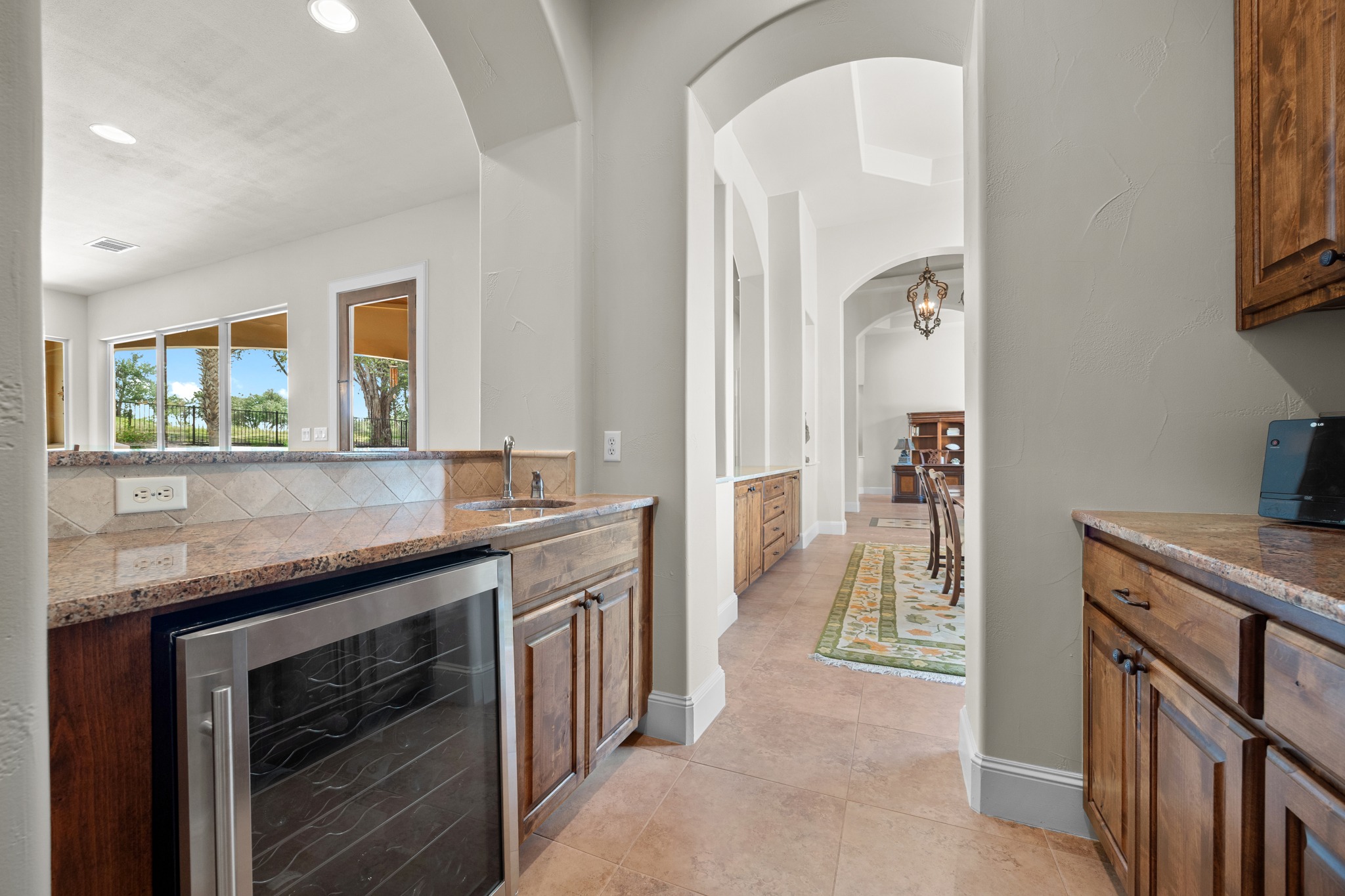 Open family room with wet bar and natural light