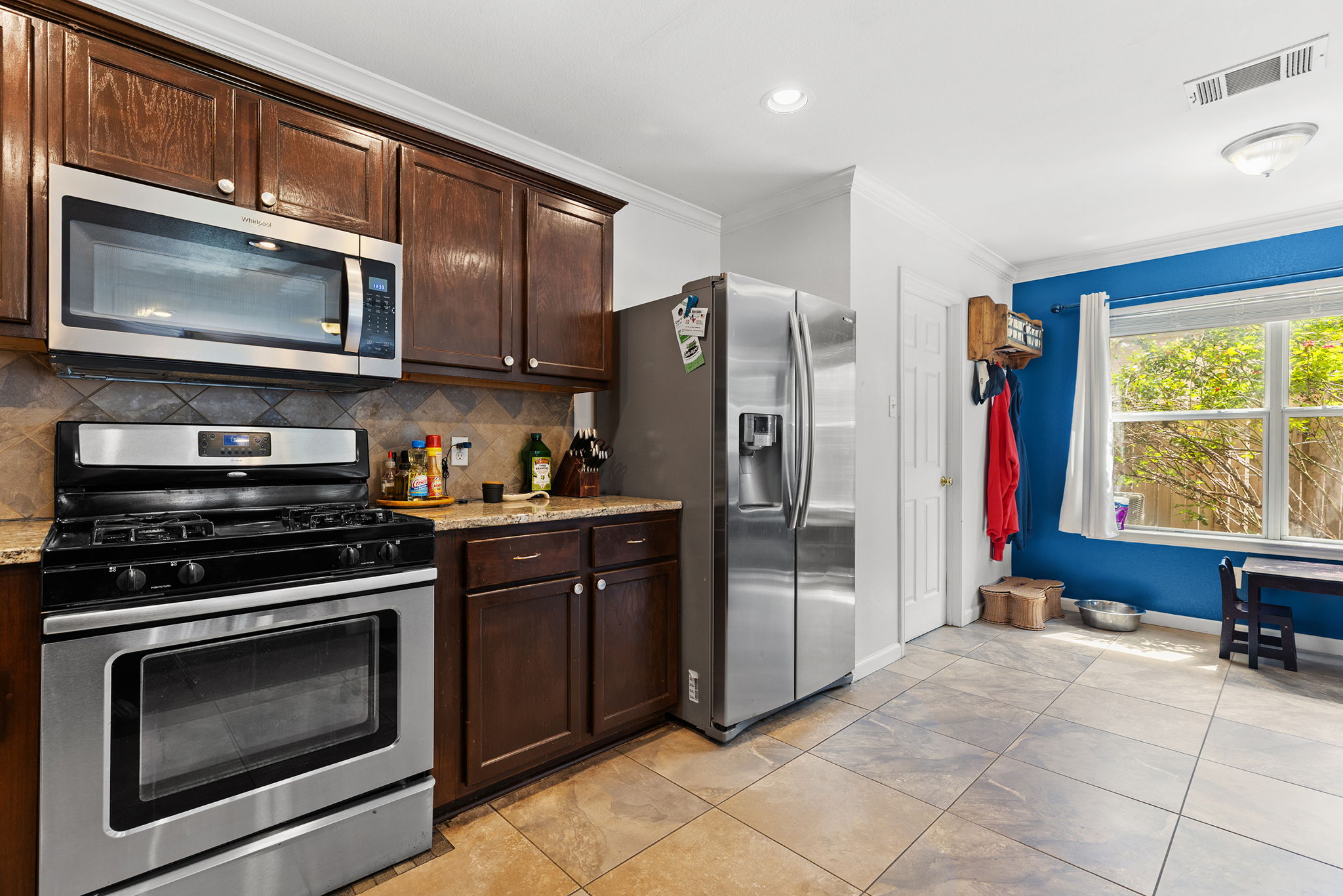 Chef's kitchen with granite counters, breakfast bar and stainless appliances