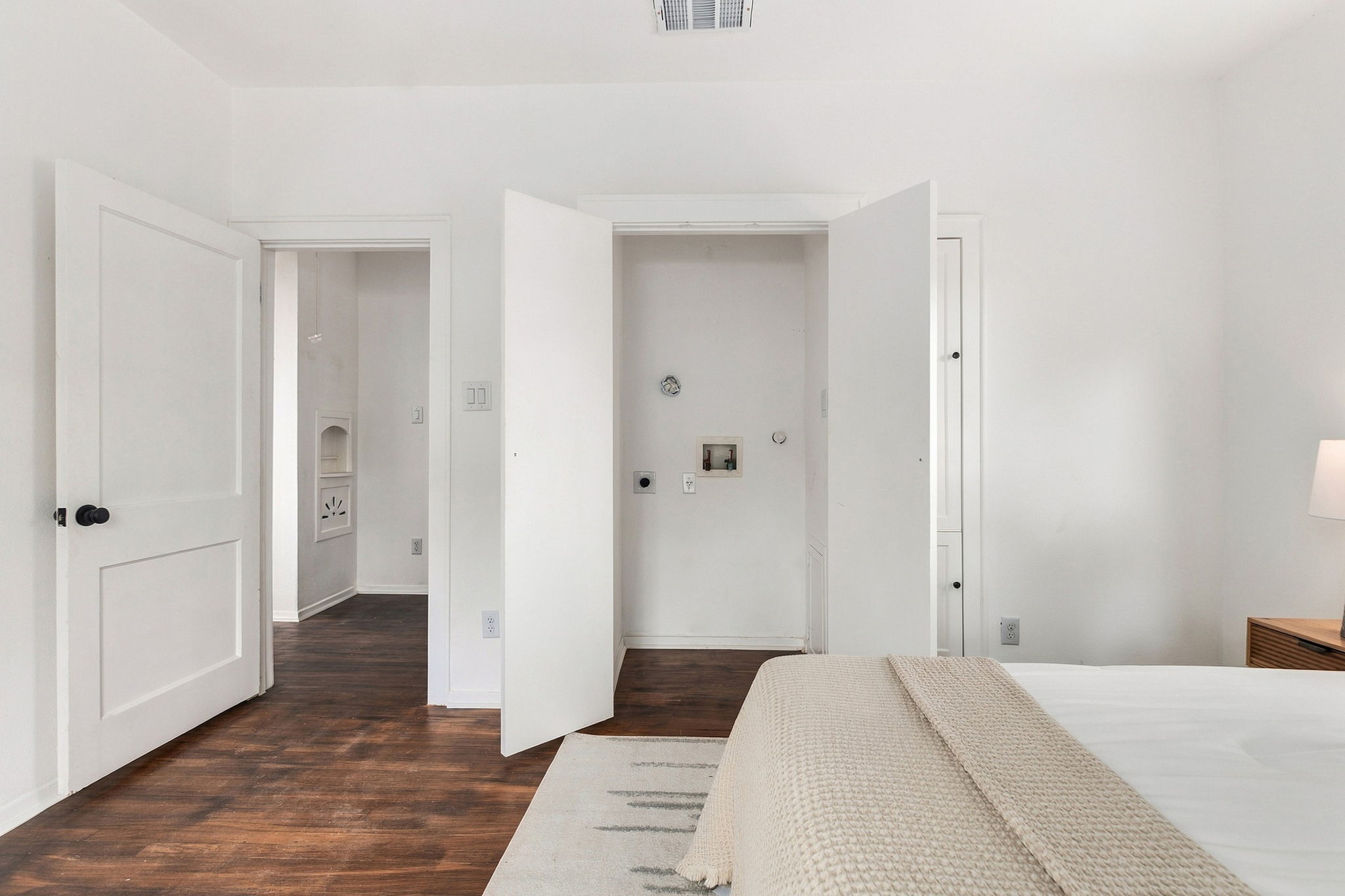 Primary bedroom with the laundry closet open