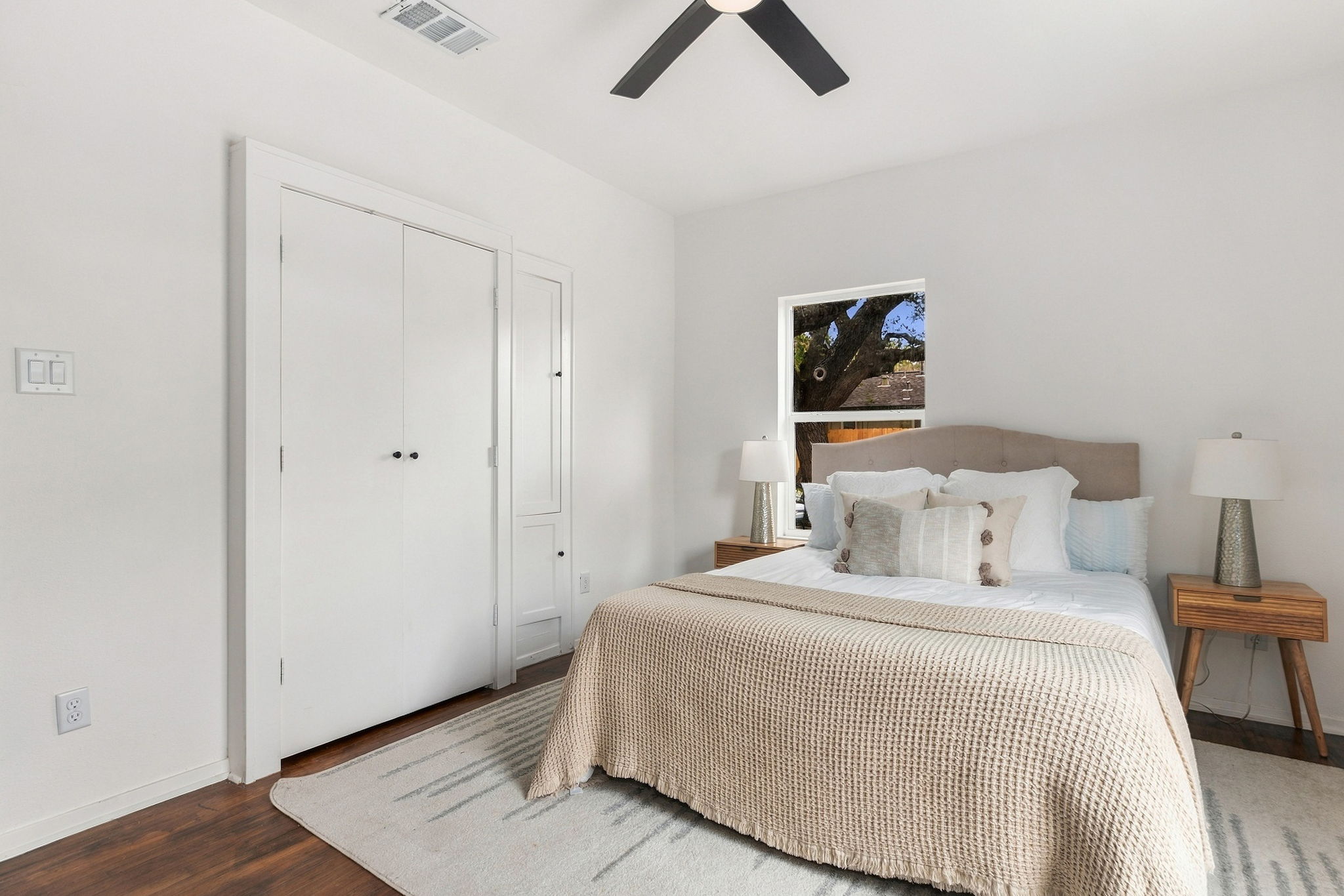 Primary bedroom with a double-door closet