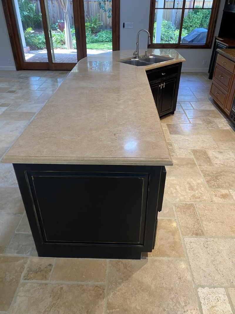 Polished and sealed travertine kitchen island and floor in a San Jose home