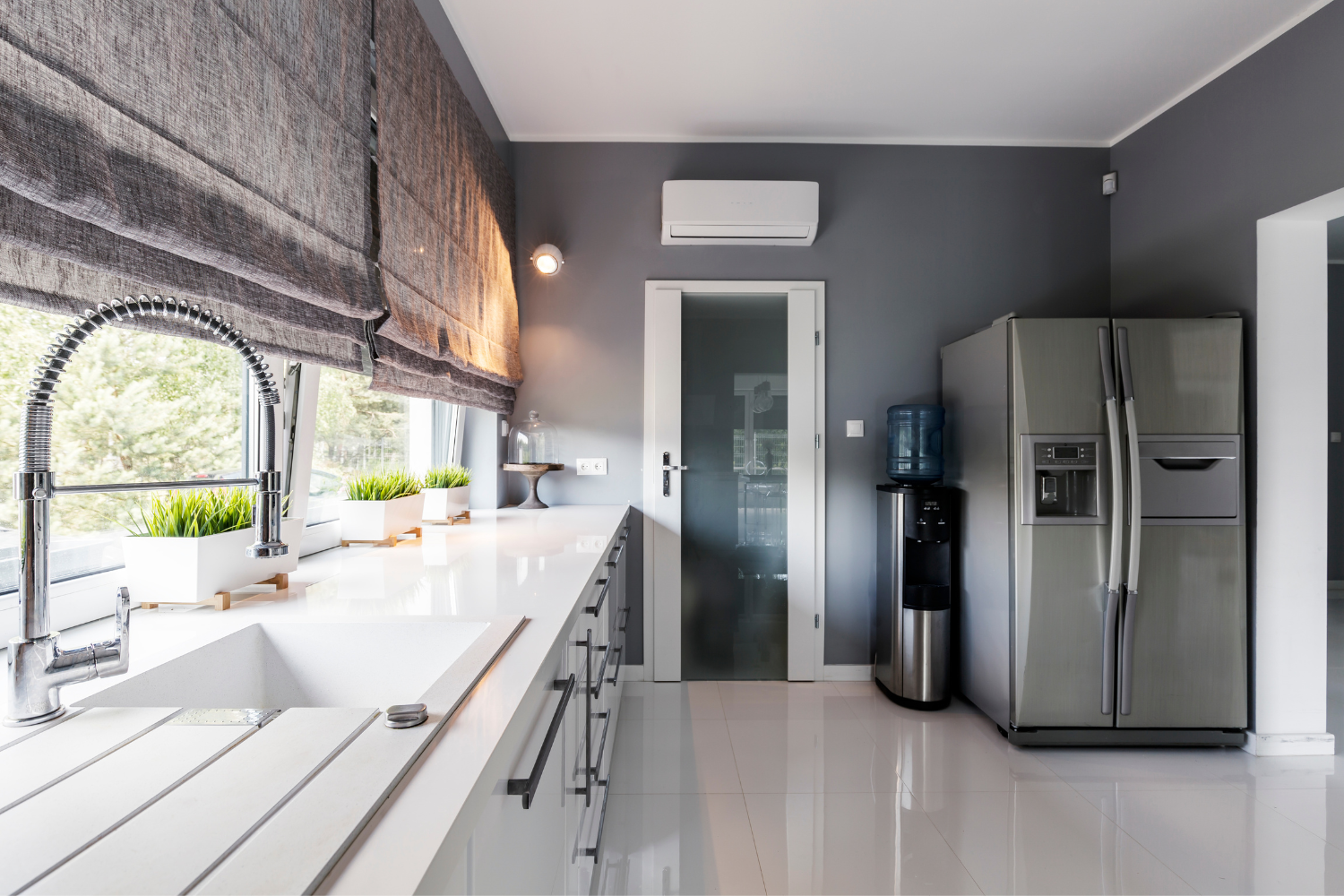Custom motorized roller shades in a modern Malibu kitchen providing light control, privacy, and contemporary style Custom motorized roller shades in a modern Malibu kitchen providing light control, privacy, and contemporary style