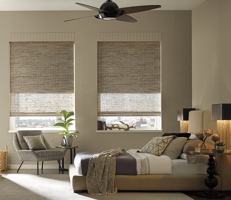 Custom woven window shades in a modern bedroom provide natural light control, privacy, and warm texture. Custom woven window shades in a modern bedroom provide natural light control, privacy, and warm texture.
