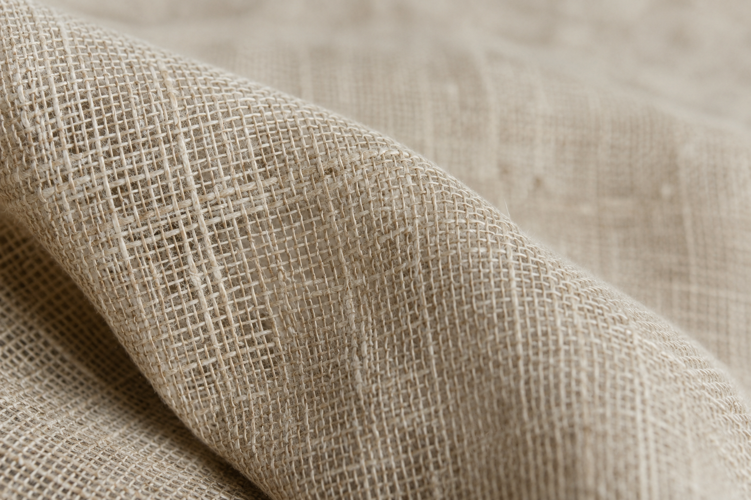 Close-up of natural linen drapery fabric showing an open, absorbent weave Close-up of natural linen drapery fabric showing an open, absorbent weave