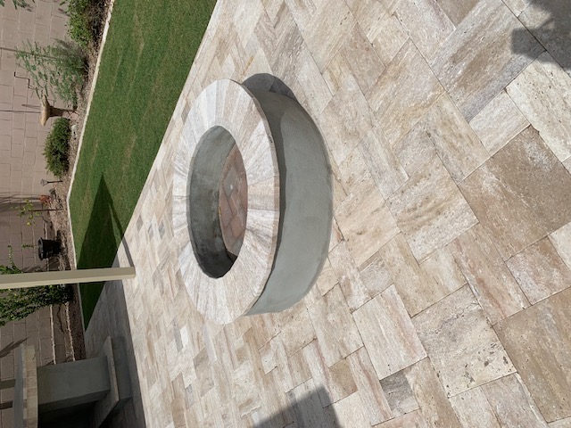 Stone outdoor living wall with TV and fireplace Arizona