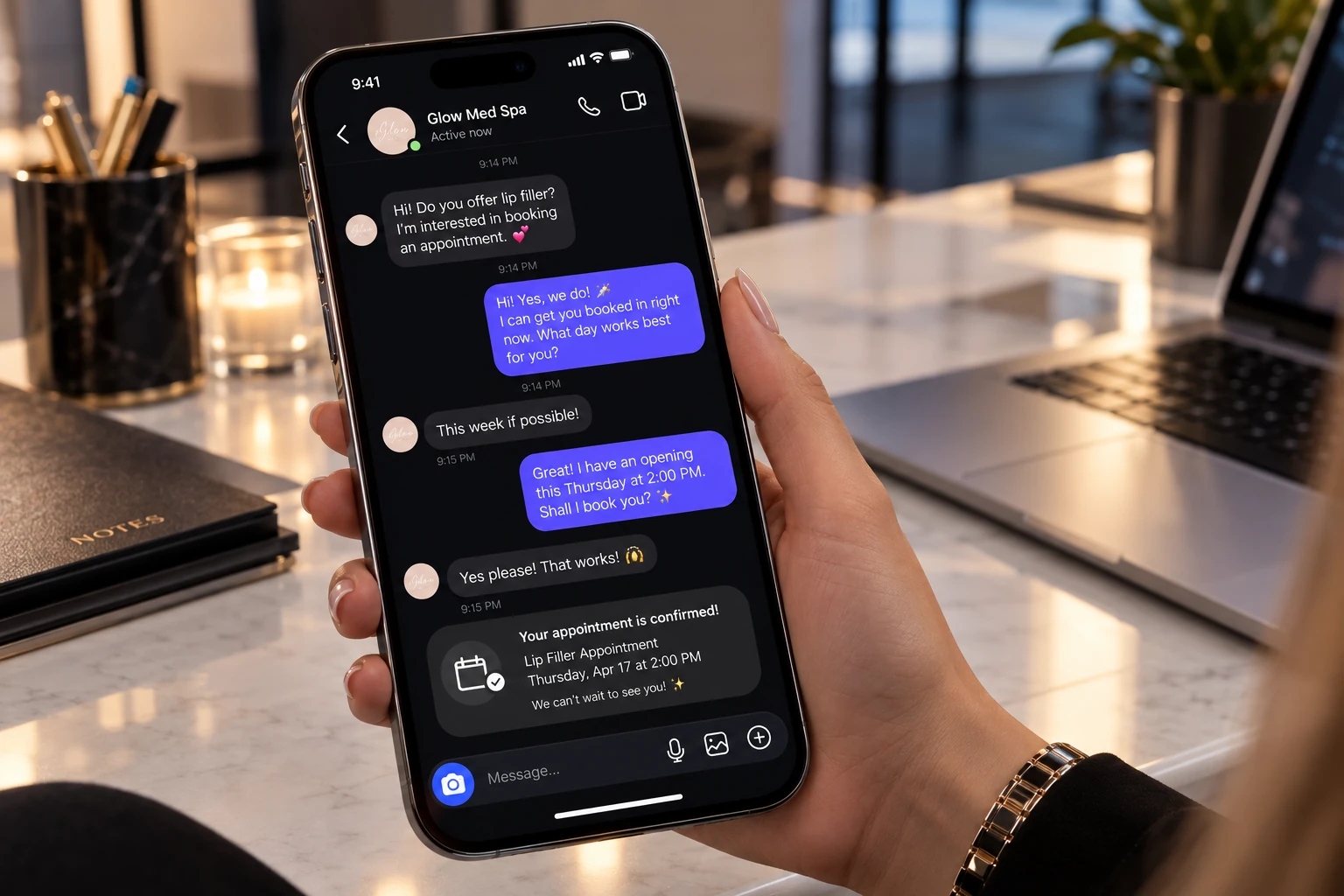 A phone on a marble desk showing a confirmed lip filler appointment in the chat