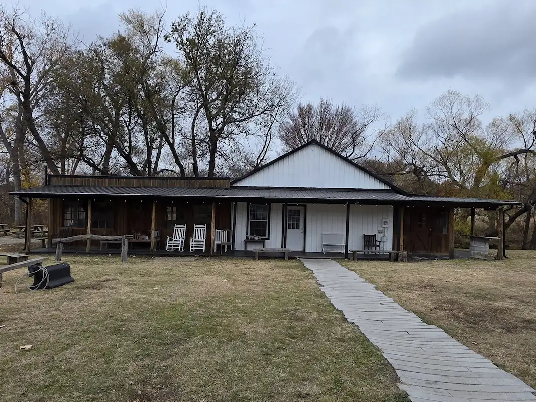 Single-story home with a long gutter run under mature trees
