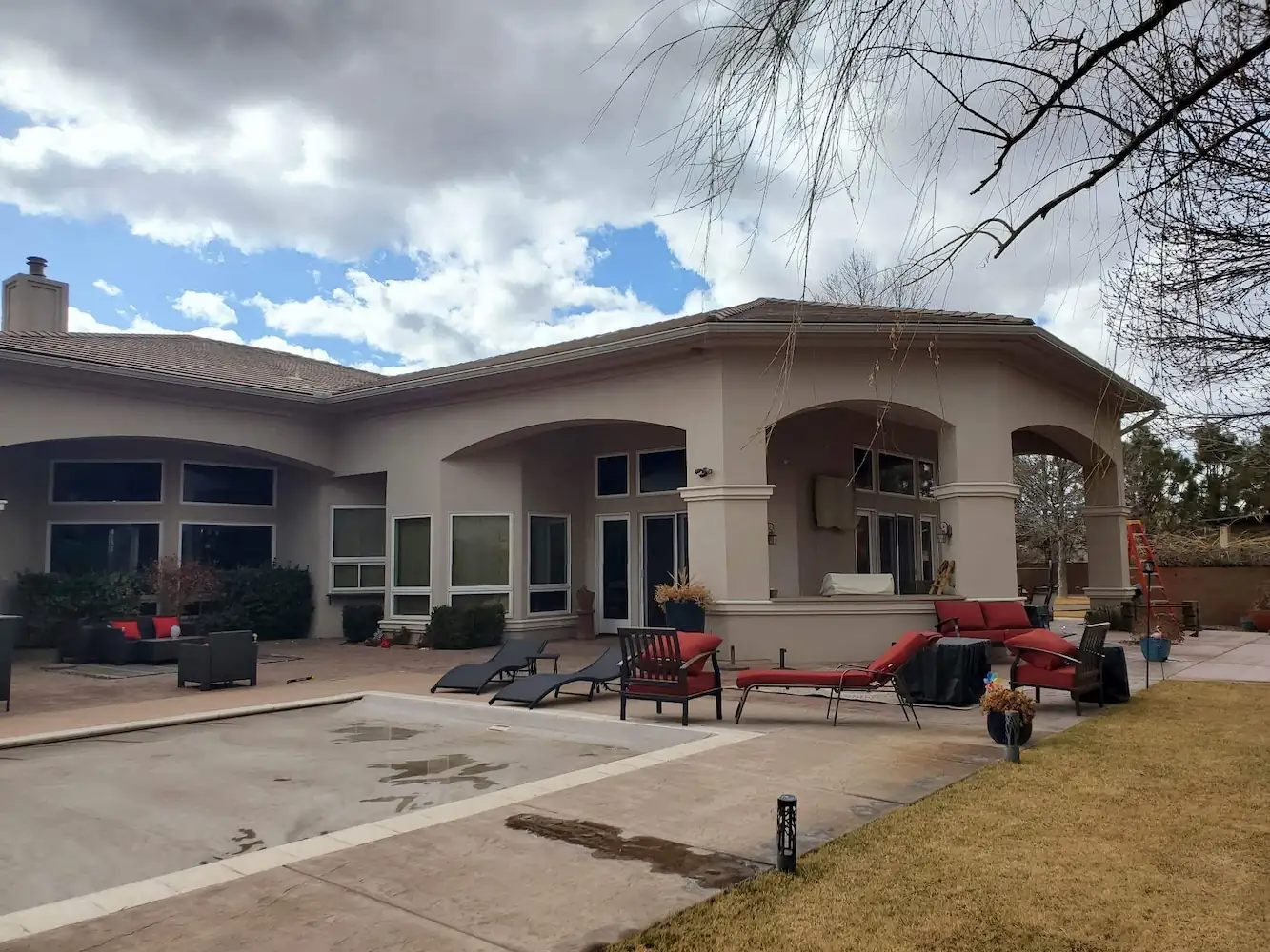 Single-story stucco home with the crew trailer parked in front
