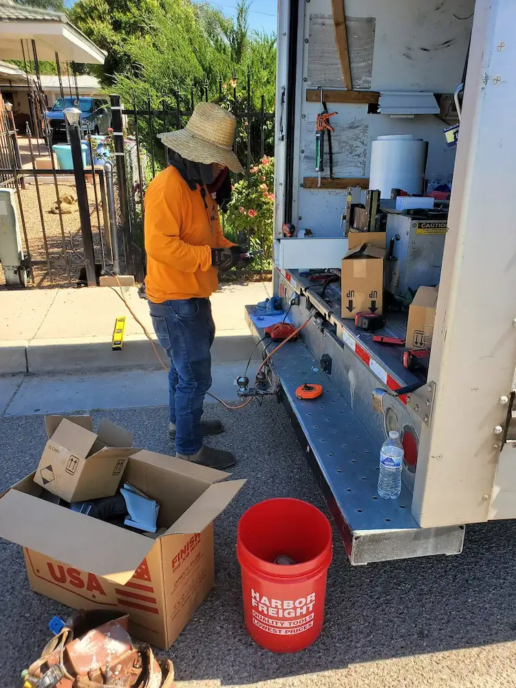 Crew member preparing gutter materials at the work trailer