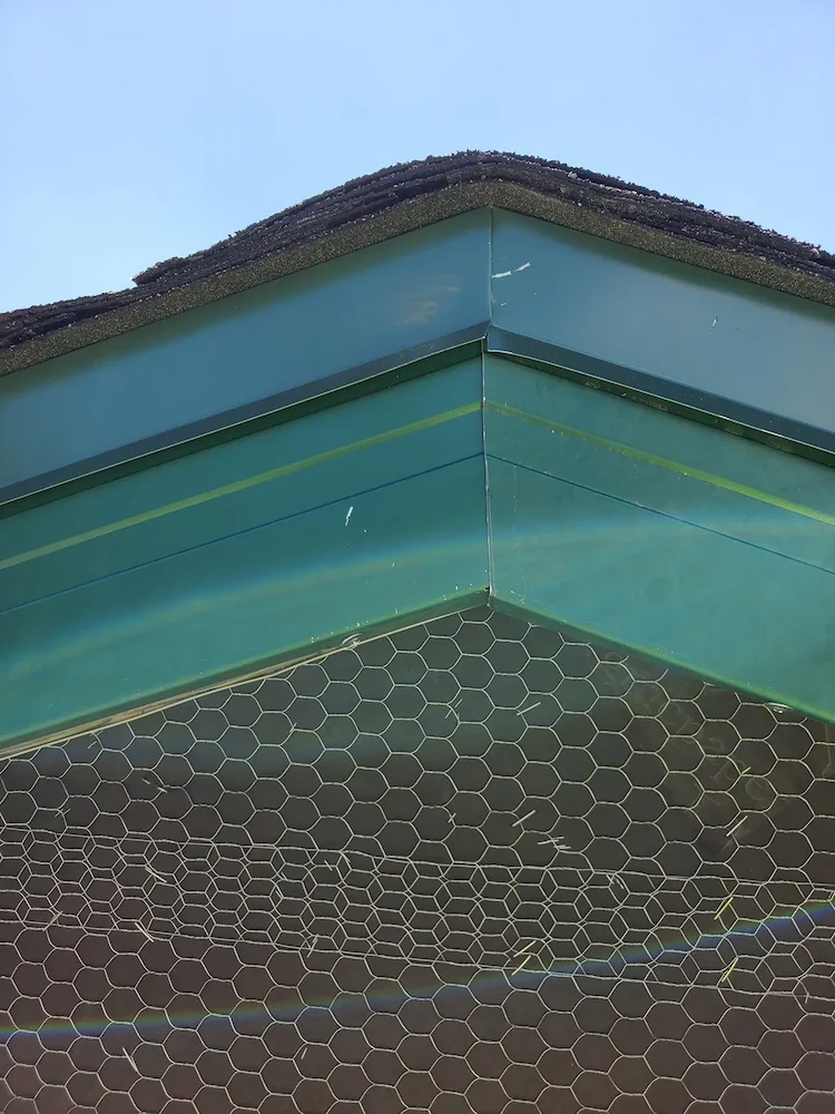 Close view of a green gutter and fascia corner