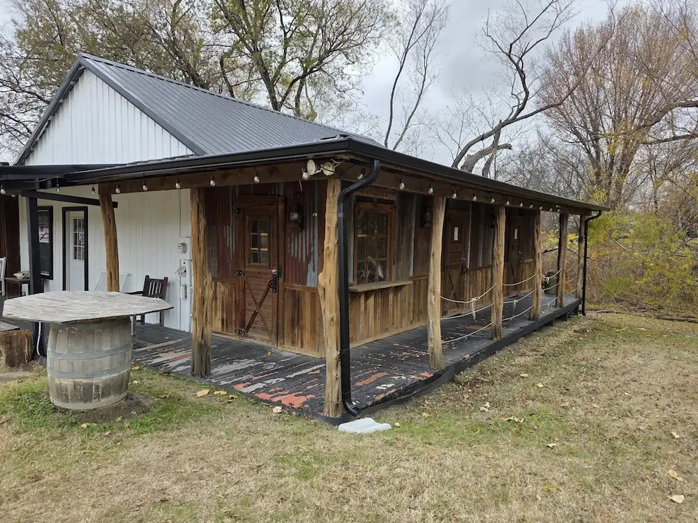 Wood-sided home with a covered porch and gutters along the roofline