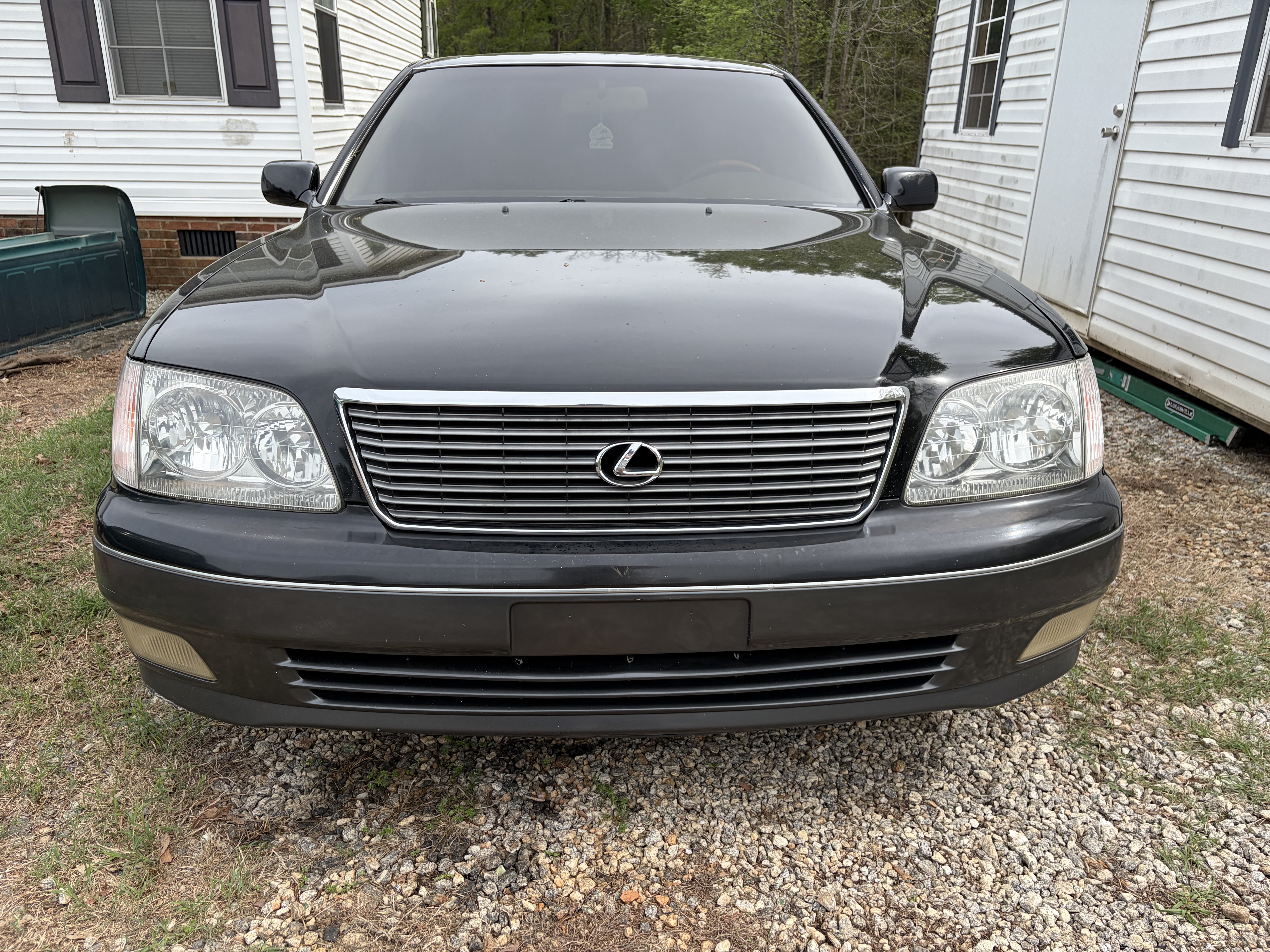 Before and after headlight restoration in Mauldin SC showing clear restored headlights next to foggy yellowed headlights