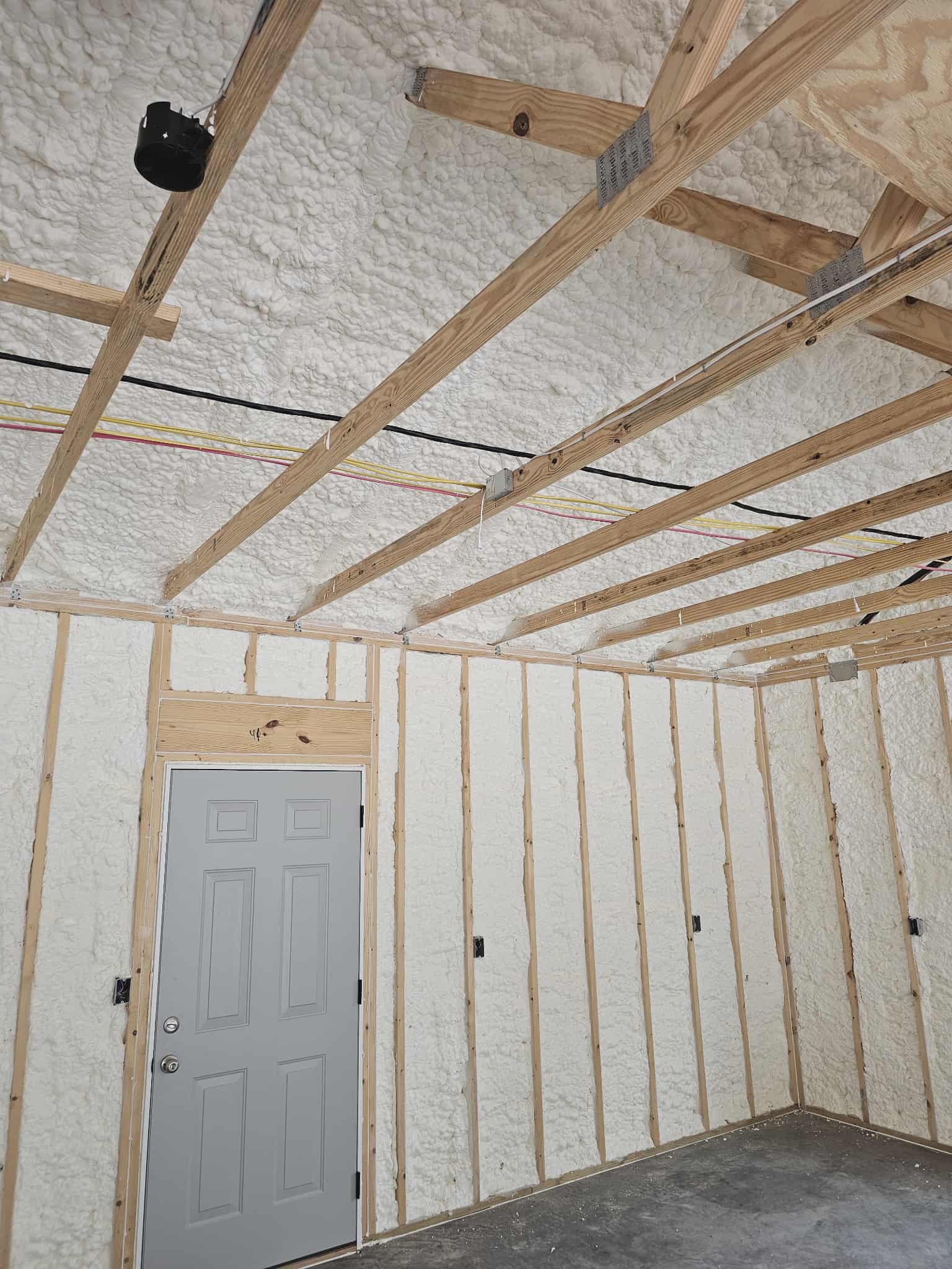 Spray foam insulation on ceiling joists and walls