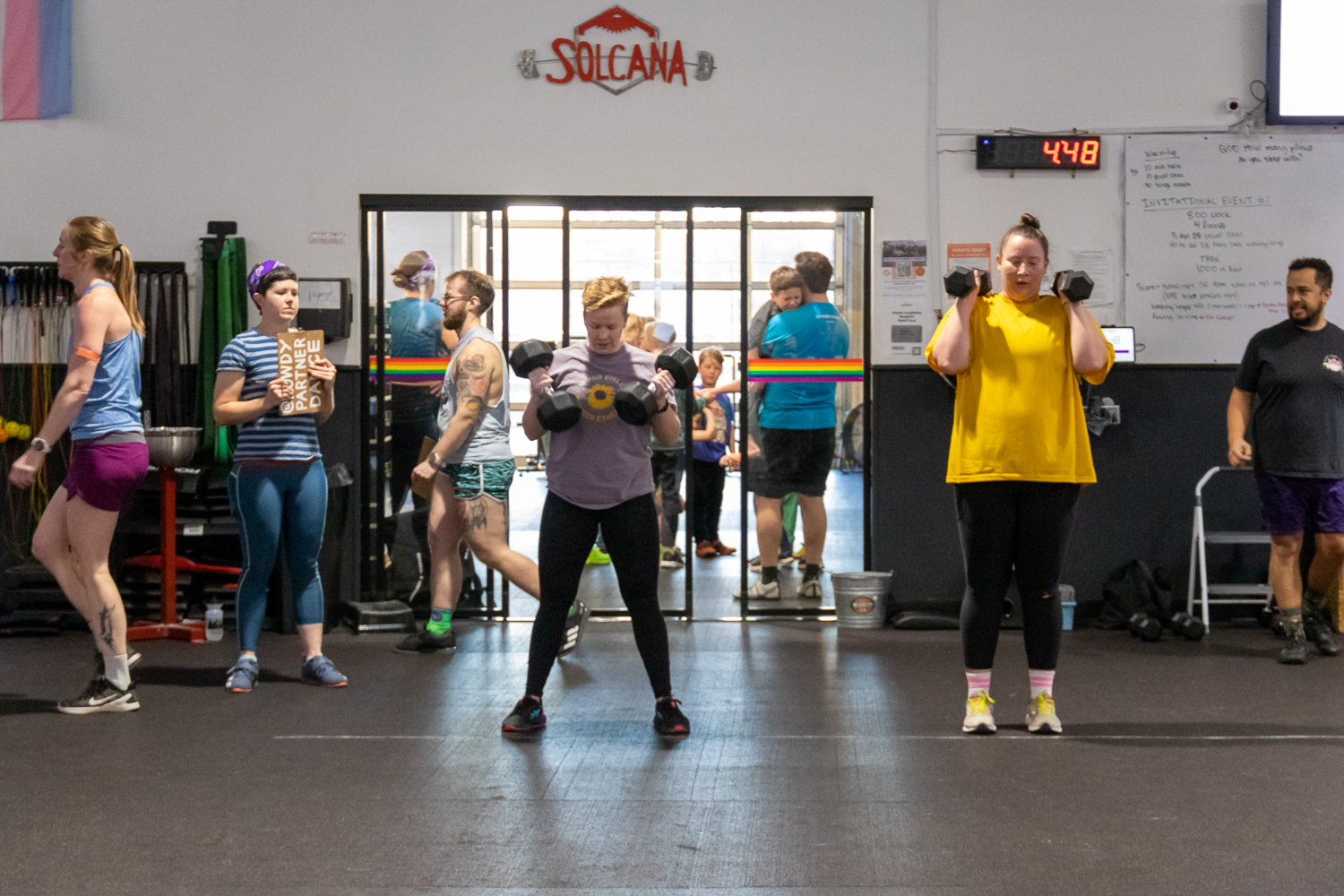 athletes lunging with heavy dumbbells