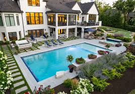 Misty hills rise above a field of green plants.
