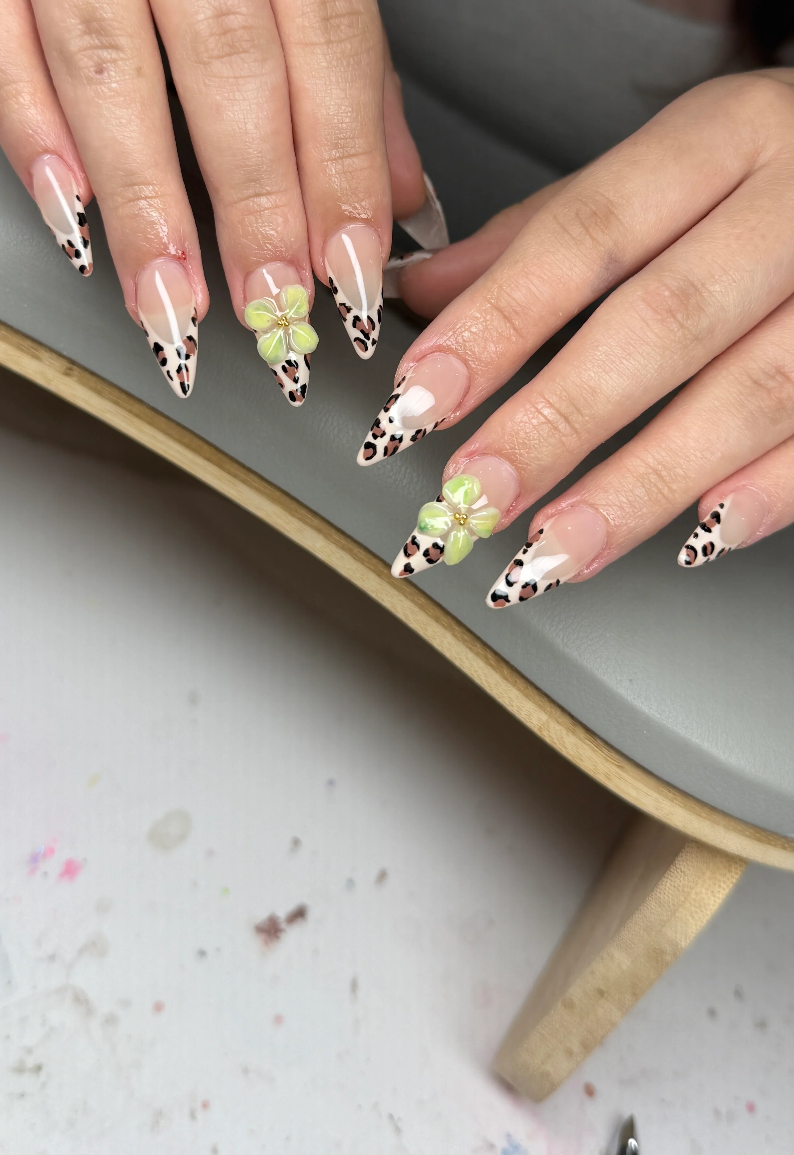 leopard French nail design with green 3D flowers and almond acrylic nails by Ballerina Nails and Spa