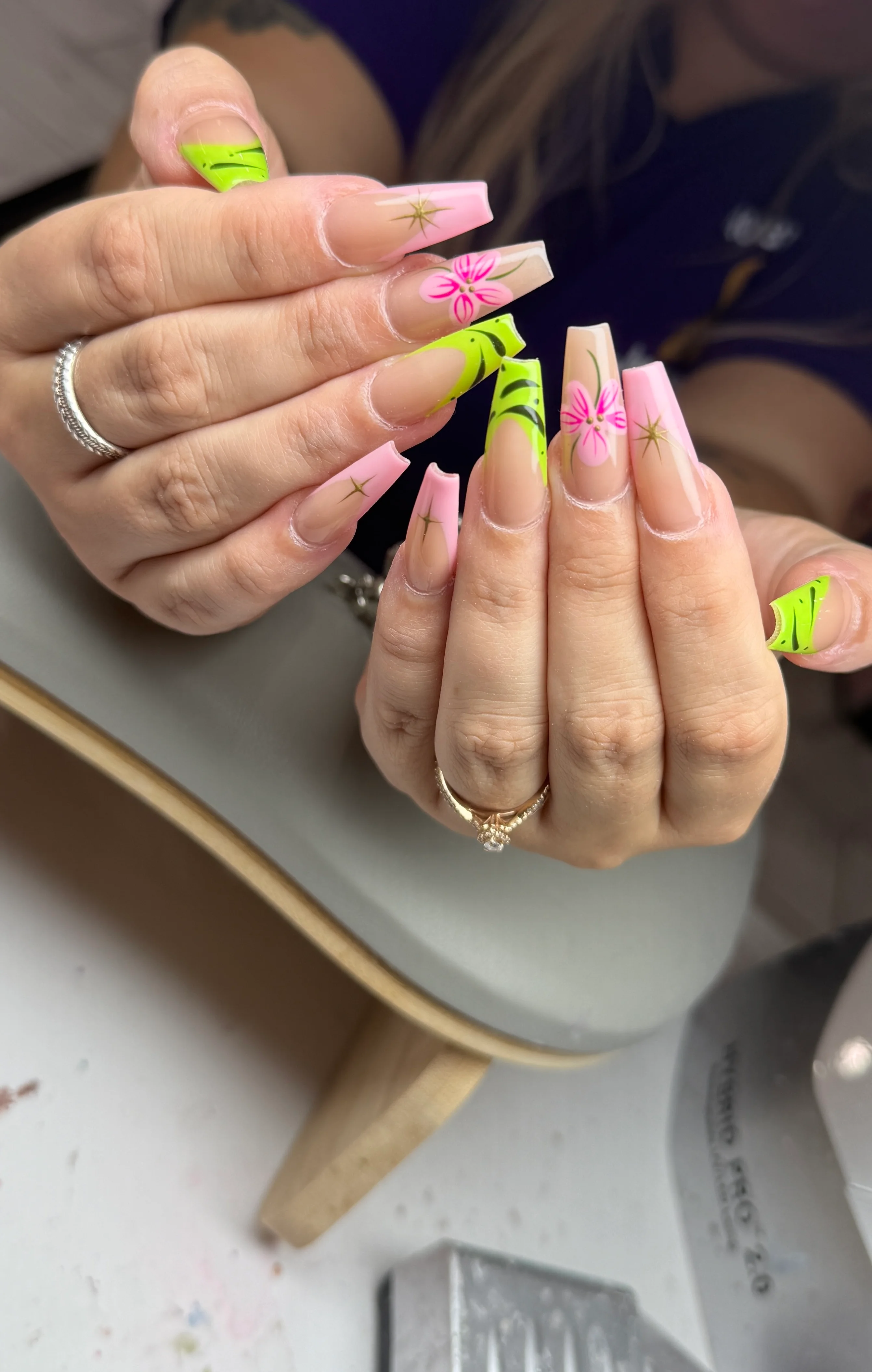 neon pink and green floral French nail design with hand-drawn flowers by Ballerina Nails and Spa