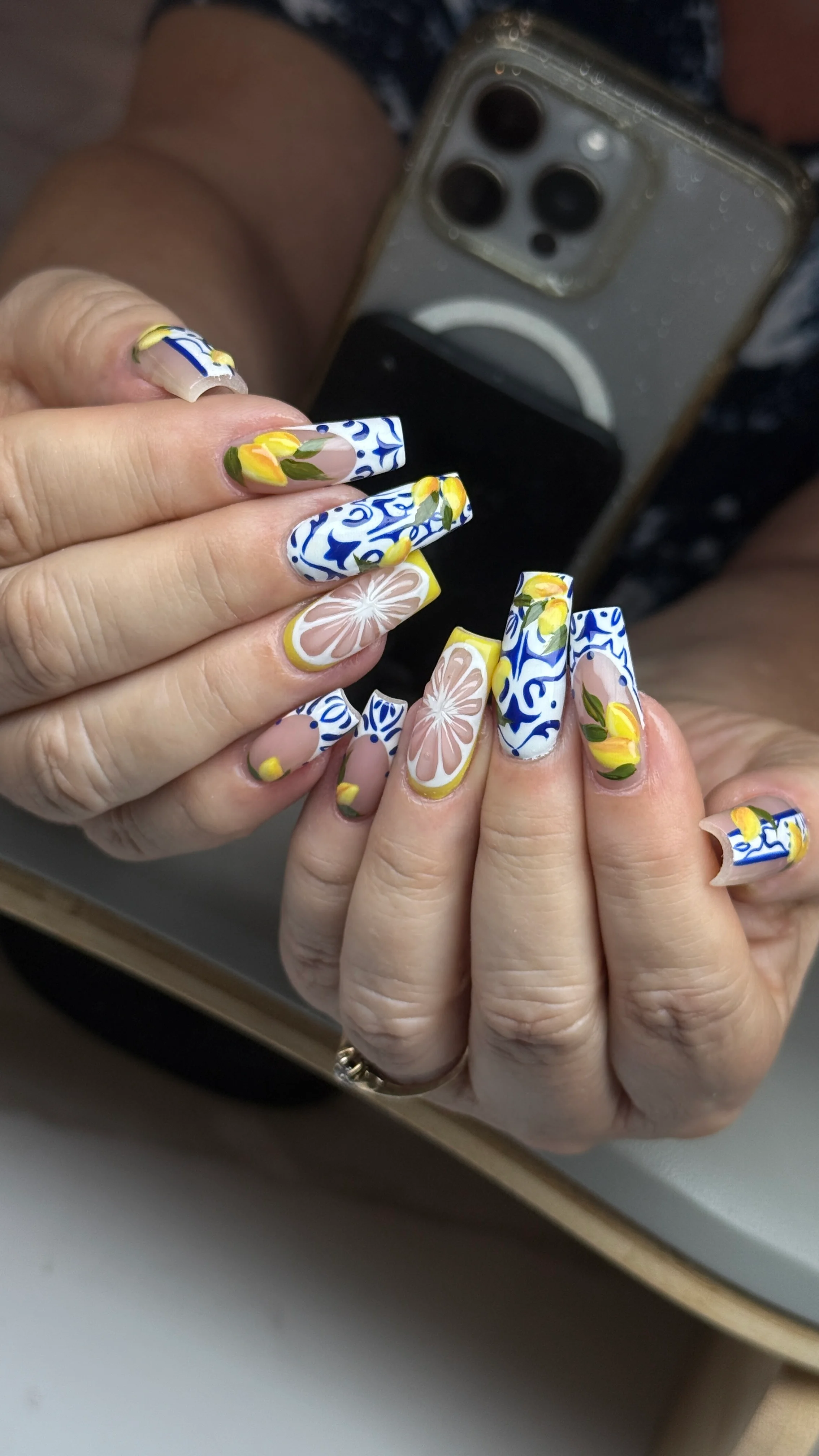 Mediterranean blue tile and lemon nail design with citrus and floral details by Ballerina Nails and Spa