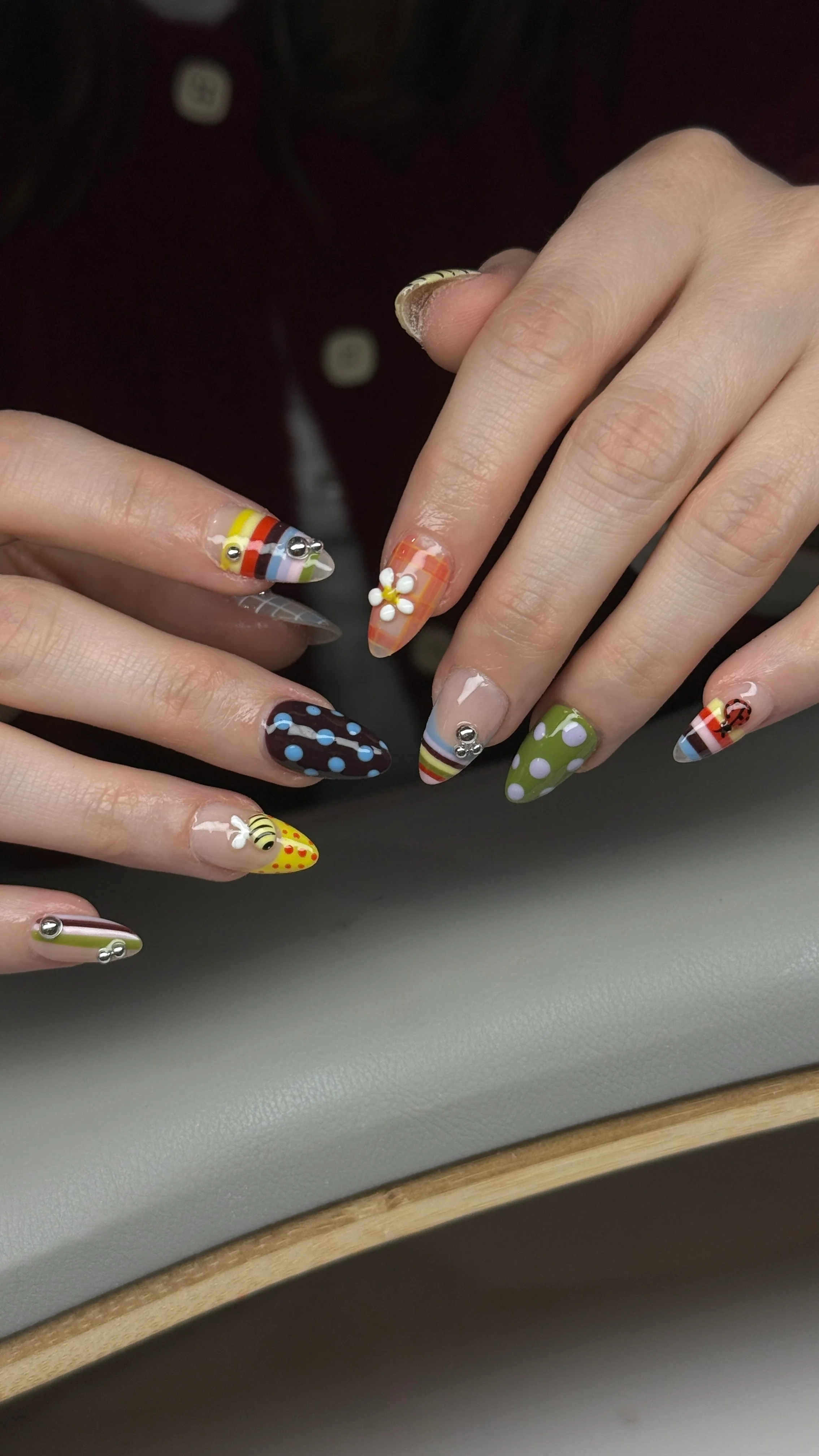 playful mixed pattern nail art with polka dots, flowers, stripes, rhinestones, and colorful designs by Ballerina Nails and Spa