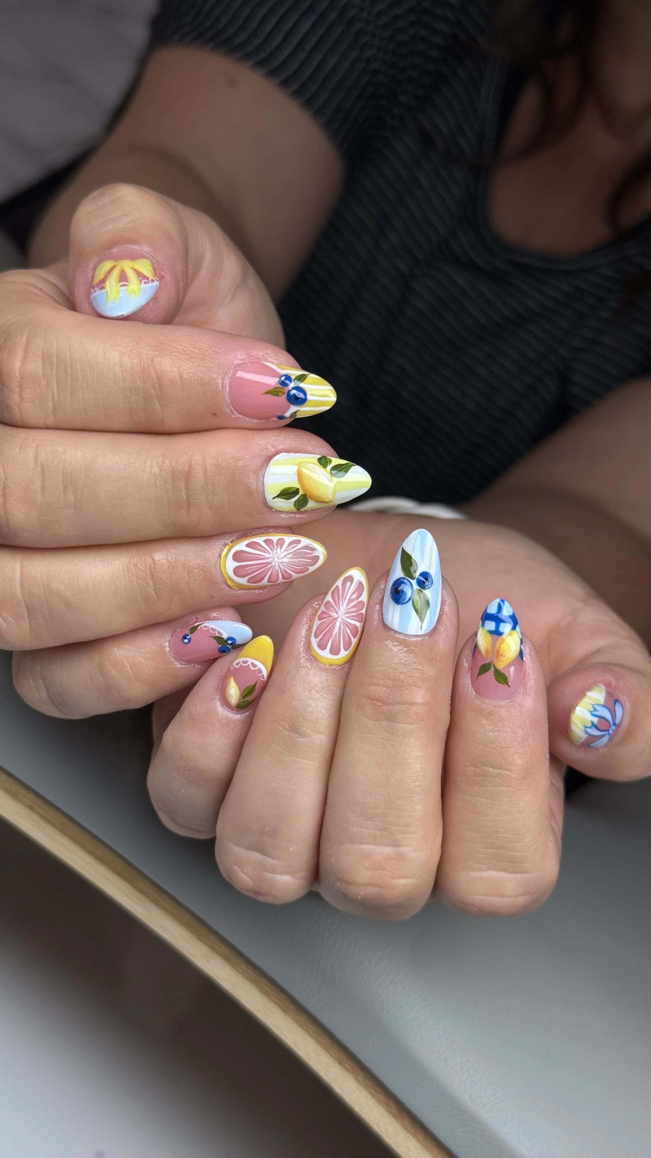 lemon, blueberry, and citrus inspired nail art with yellow and blue details by Ballerina Nails and Spa