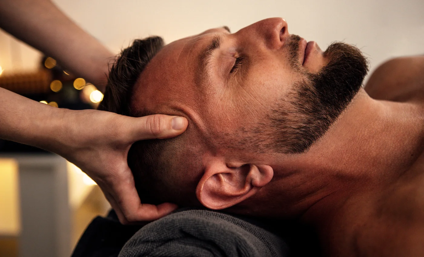 A technician is working on a client's head spa service