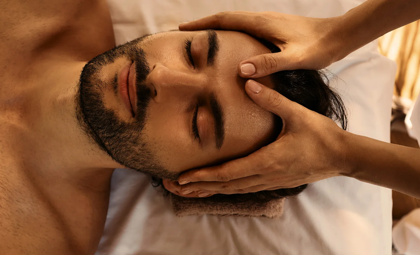 A technician is working on a client's head spa service