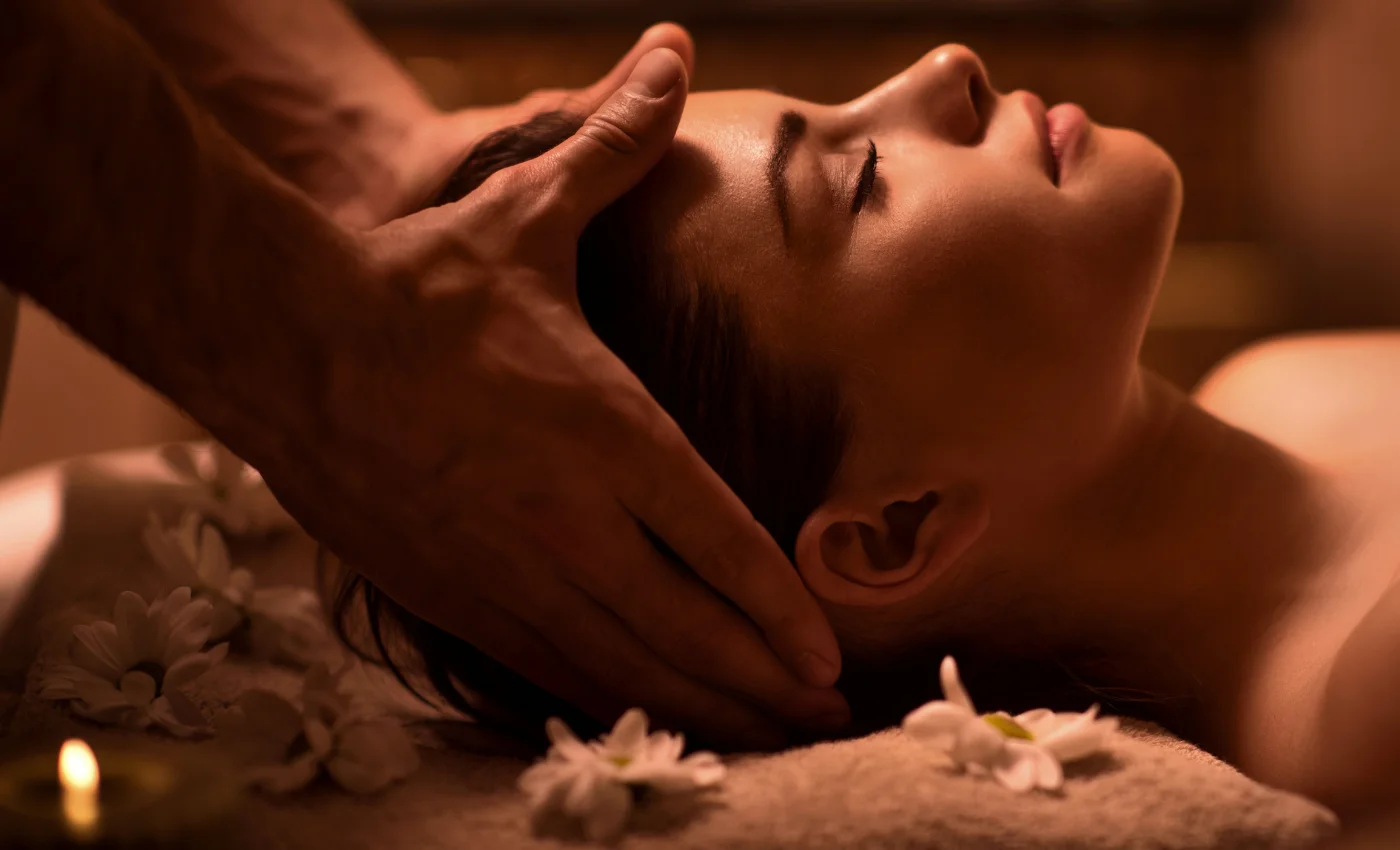 A technician is working on a client's head spa service
