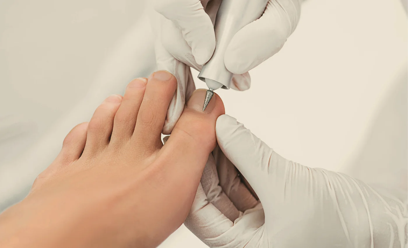 a nail technician is massaging a person's leg in a pedicure