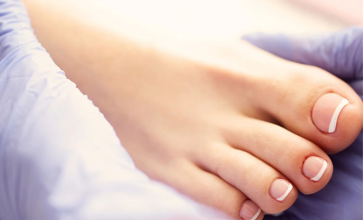 A client showing a finished Russian gel pedicure