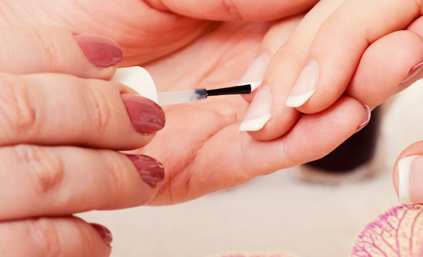 A client showing classic French dip powder nails
