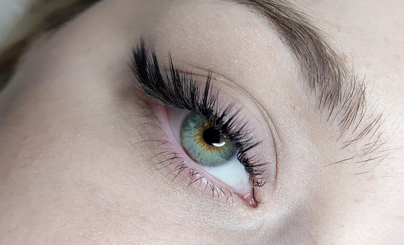 A client showing natural-looking classic lash extensions