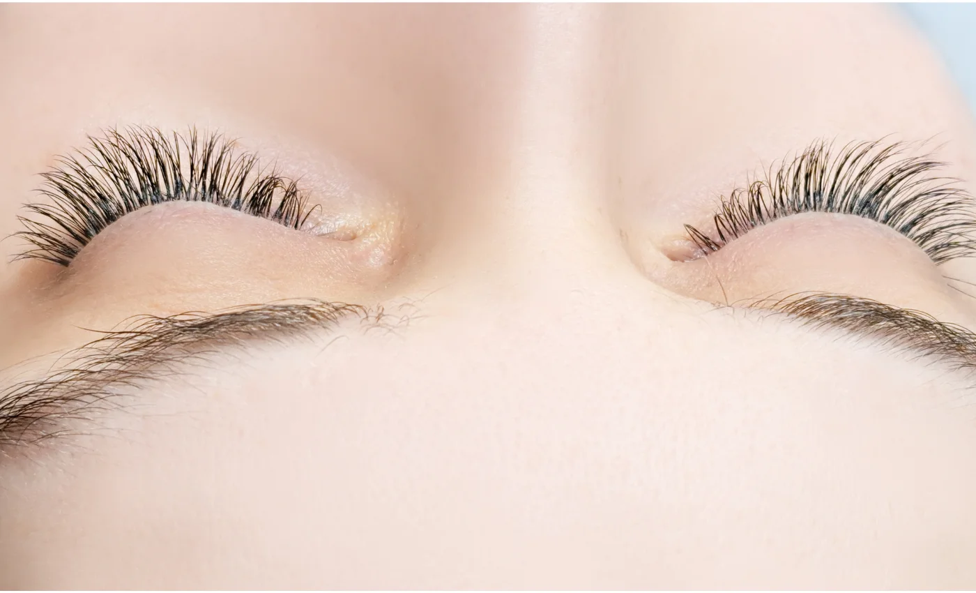 A technician applying classic lash extensions