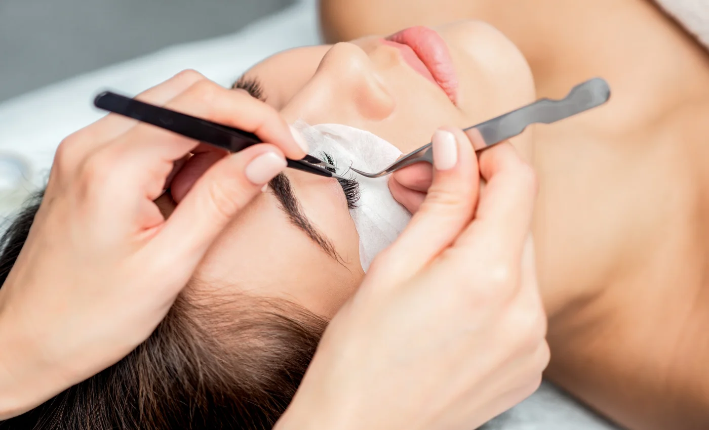 A technician applying hybrid lash extensions