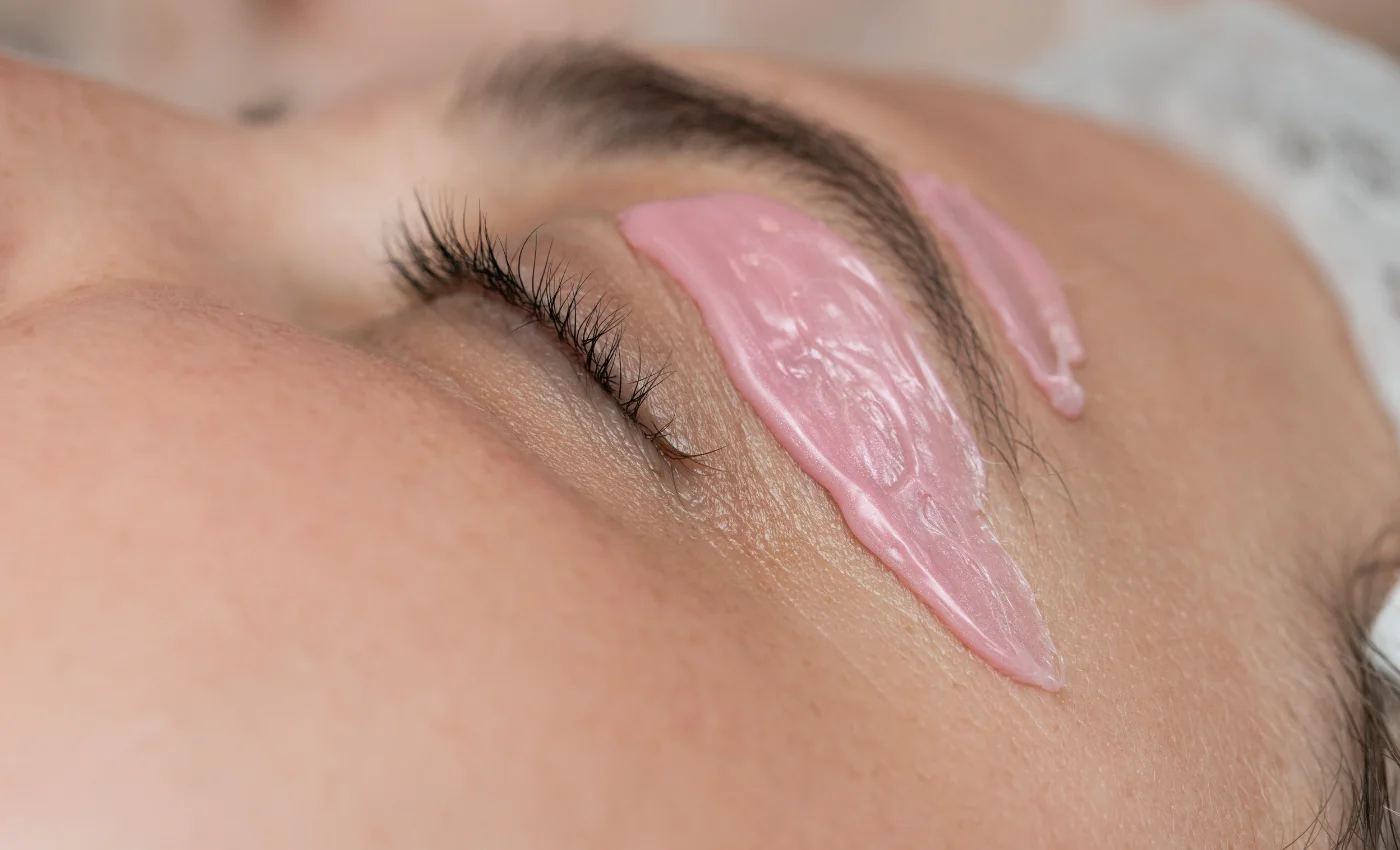A client showing clean shaped brows after a brow wax