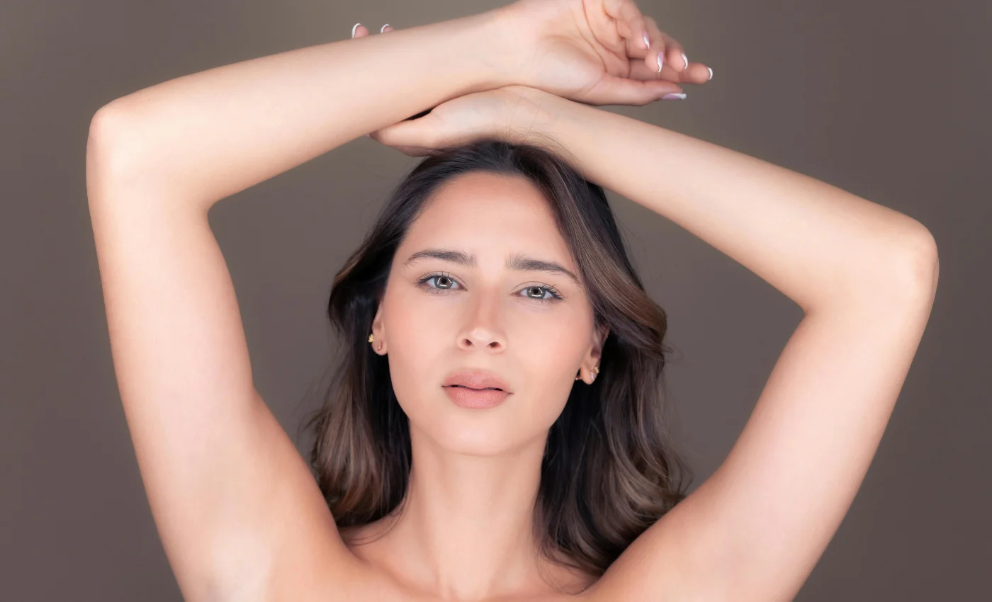 A client with smoother arms after a half arm wax