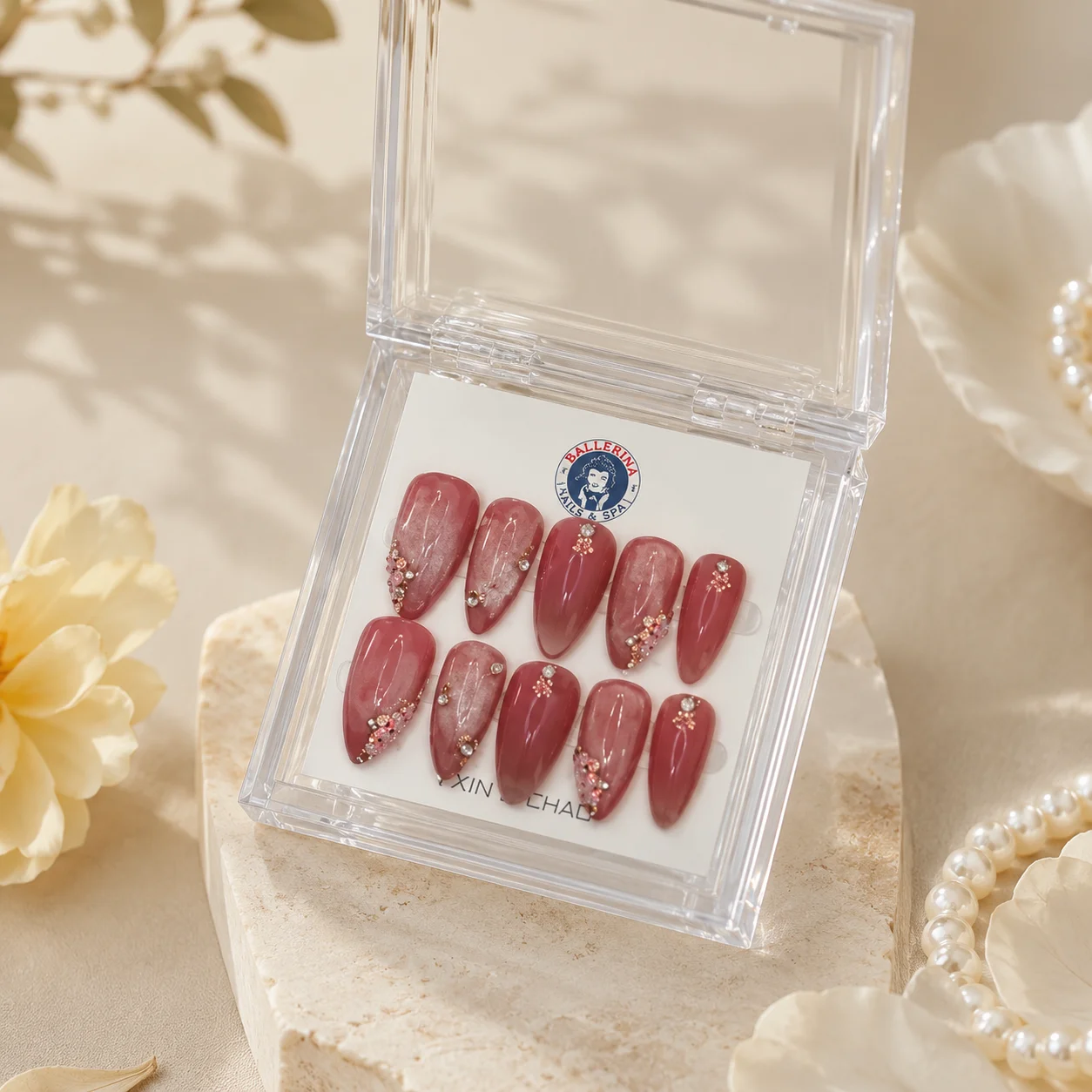 Detailed custom press-on nail art from Ballerina Nails and Spa