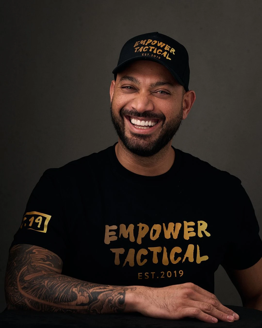 Damien Chaurémootoo smiling in an Empower Tactical cap and shirt