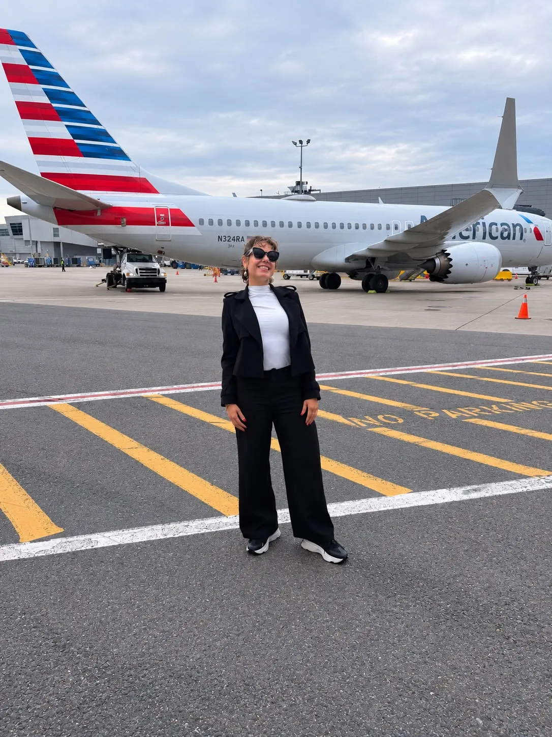 Premium Chauffeur NYC team member on the airport apron next to an aircraft.