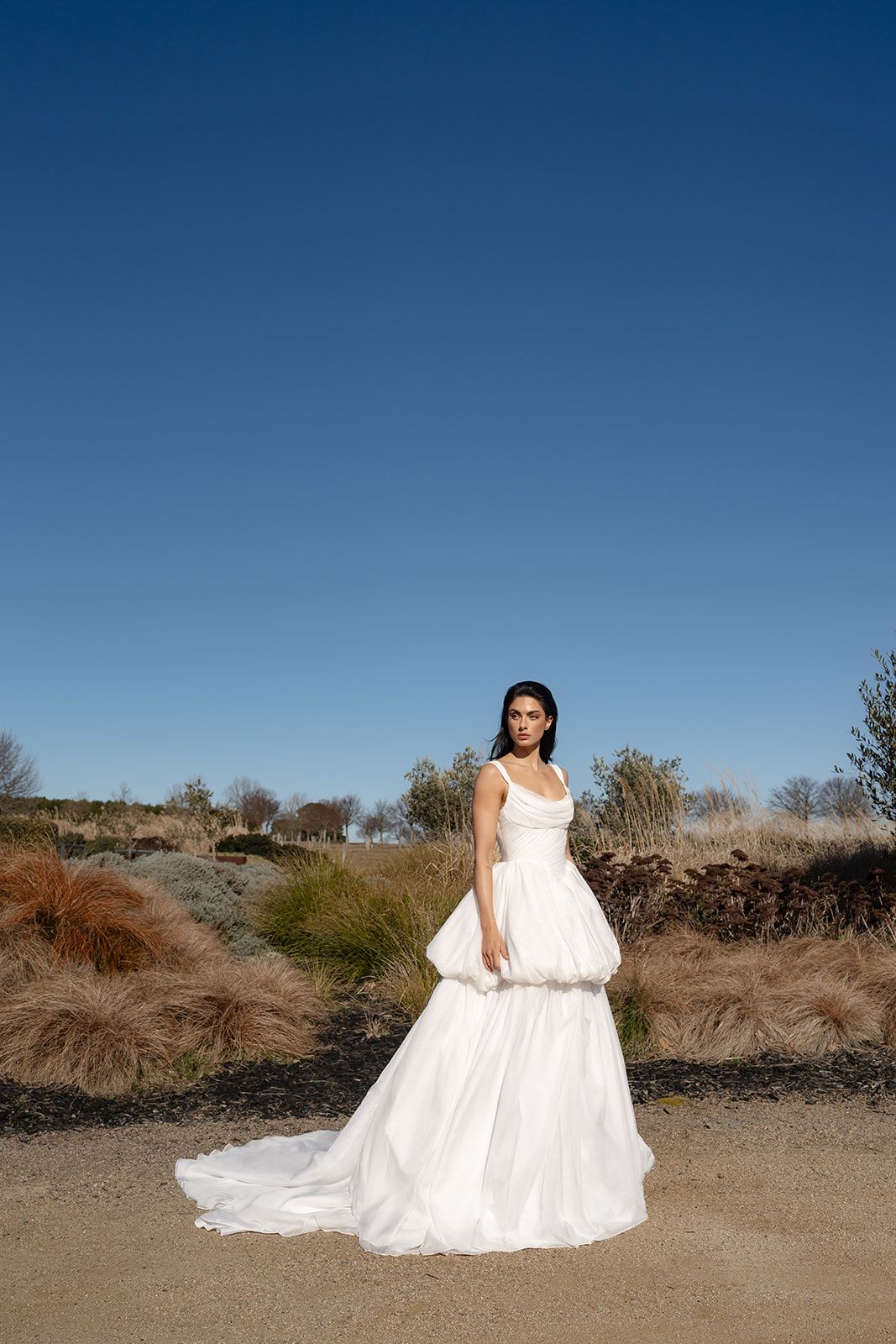The Zahlia, a chiffon A line gown in a coastal garden
