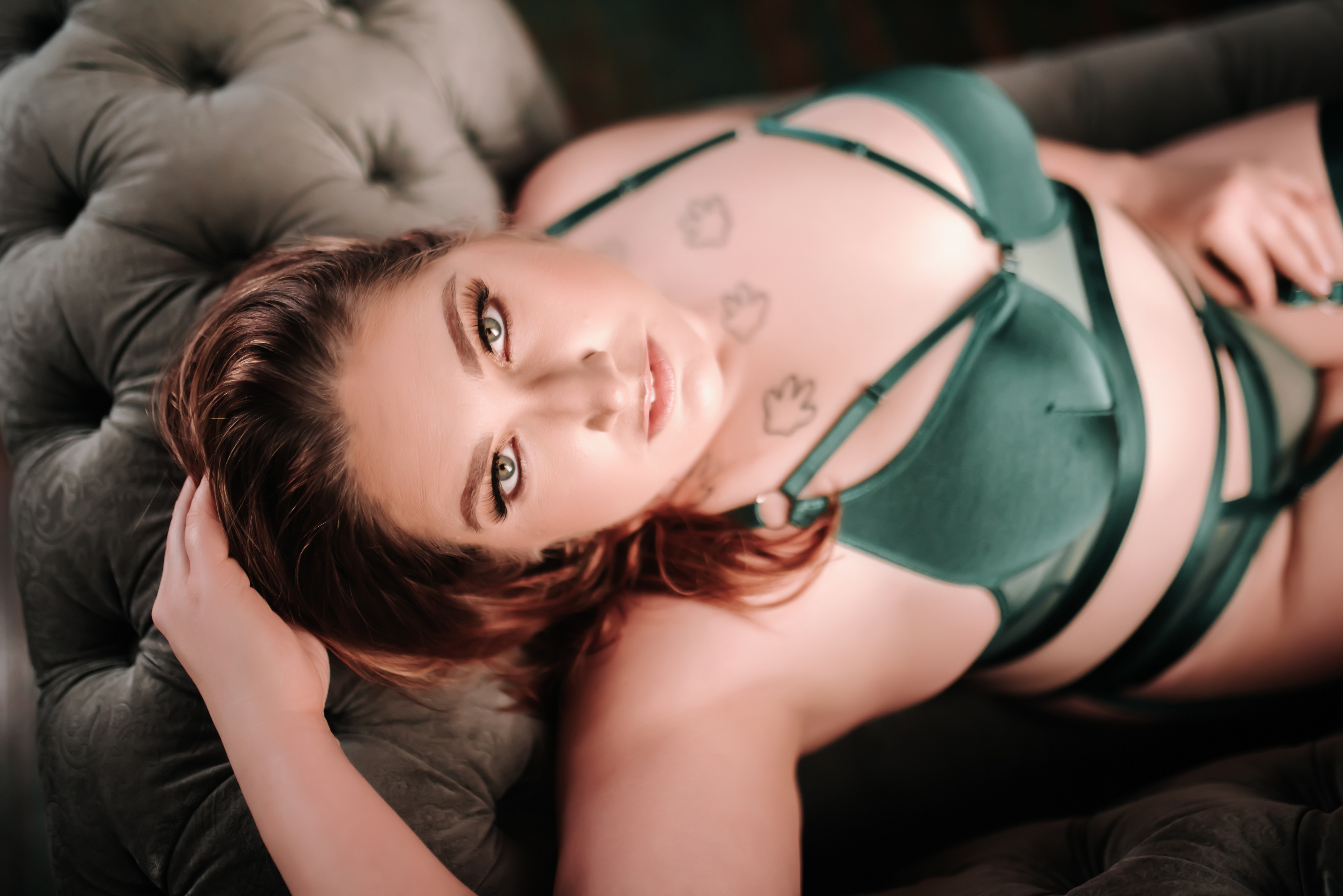 woman in green lingerie lounging on couch