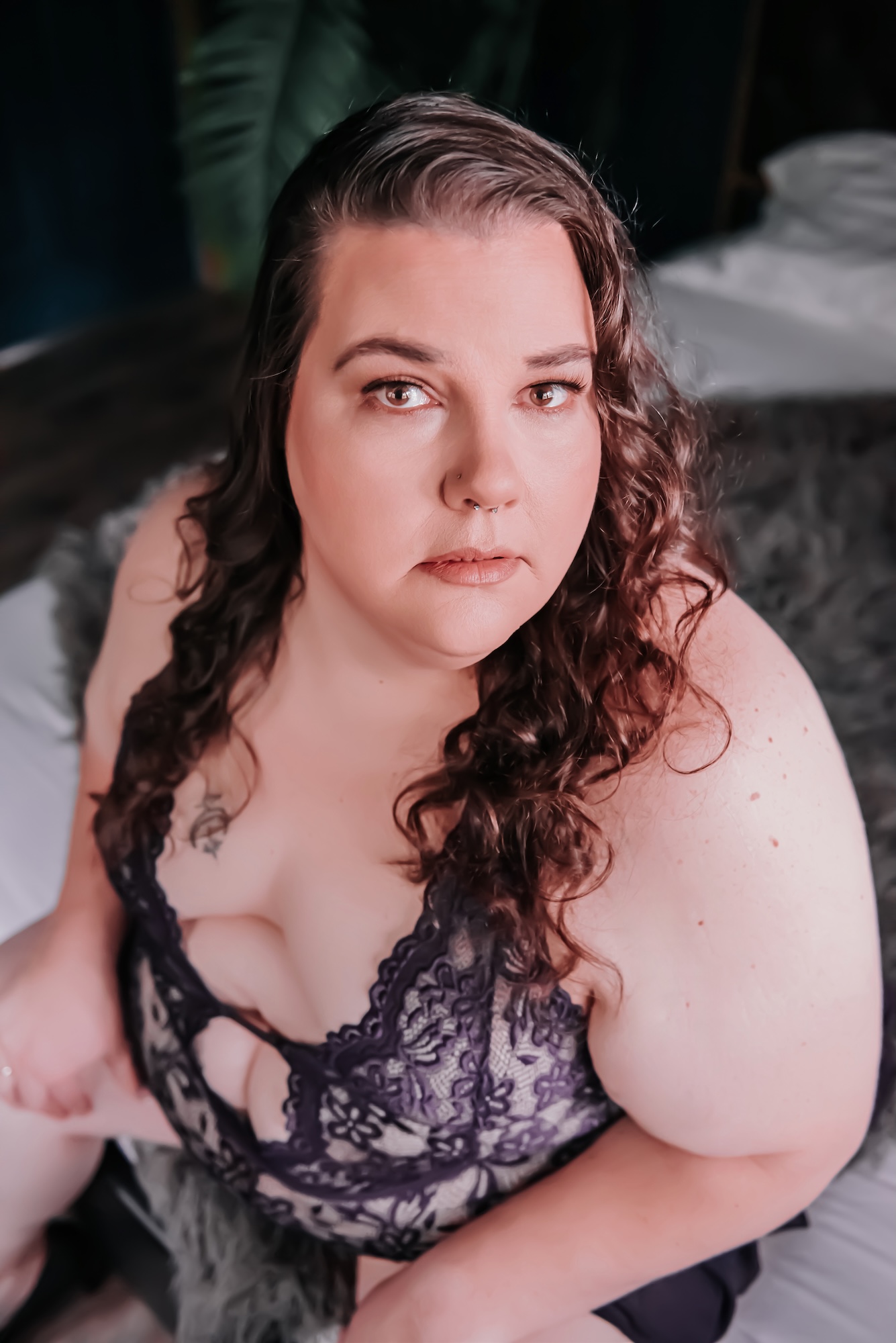 photo of red-haired woman holding a bouquet while lounging on couch