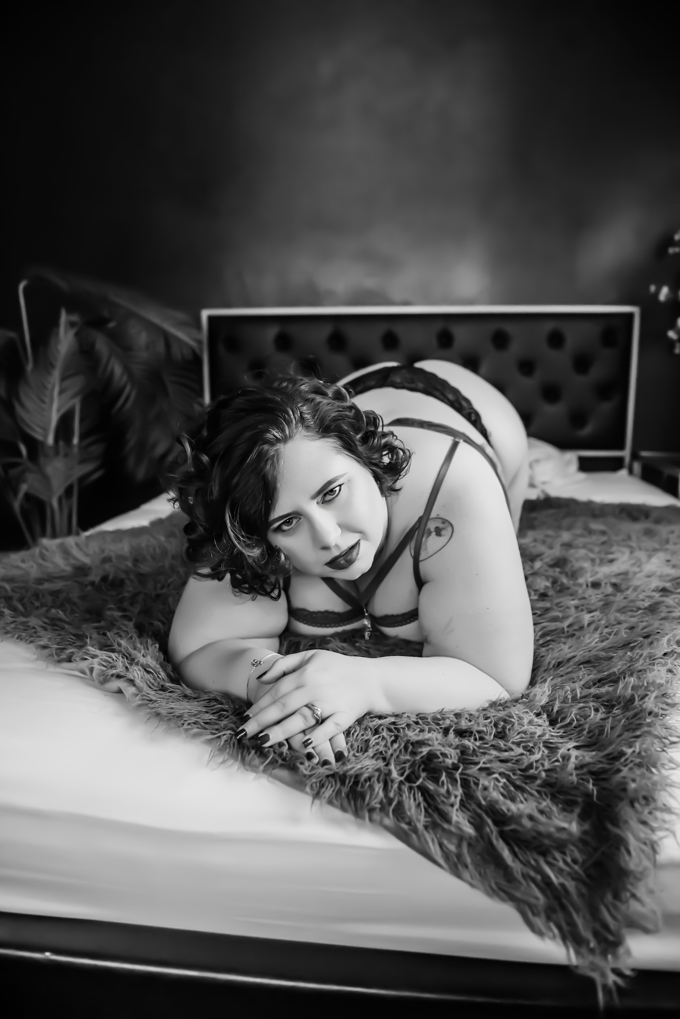 photo of red-haired woman holding a bouquet while lounging on couch