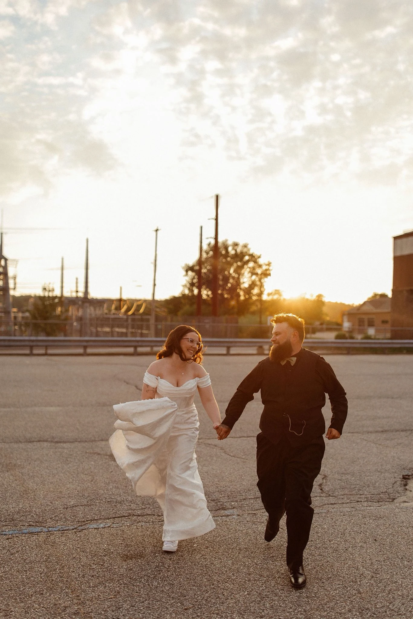 Bailey and Ben holding hands and running together at sunset