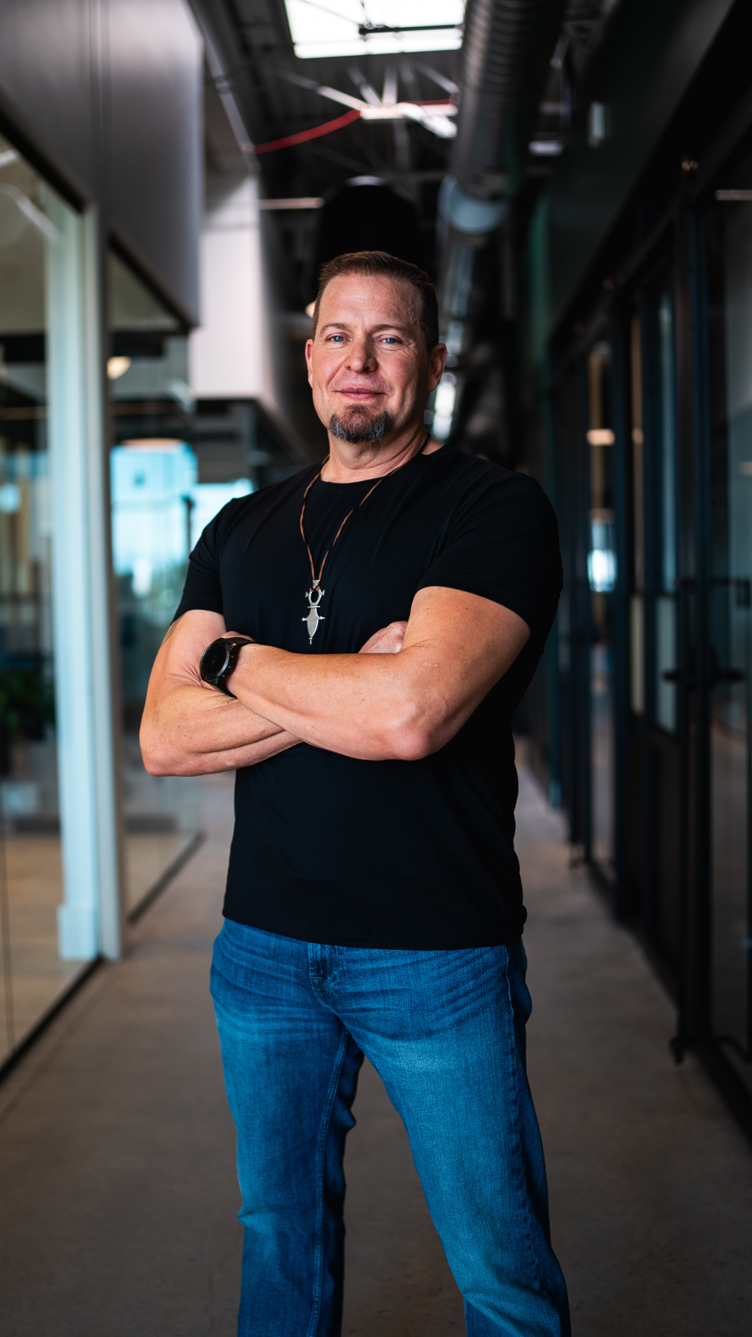 Adam Feuerstein spiritual guide and leadership coach standing confidently with arms crossed, supporting leaders and seekers in reclaiming truth and freedom